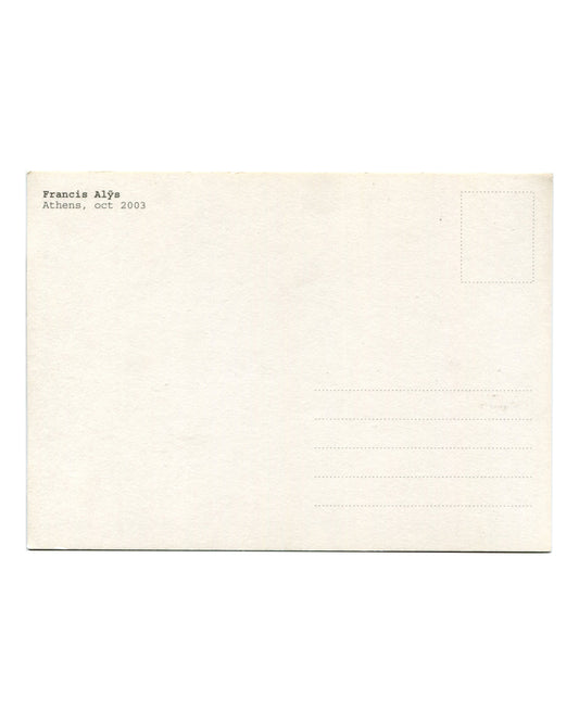 Reverse of 2003 Francis Alÿs Athens postcard. Cream stock with standard postcard layout; 'Francis Alÿs / Athens, oct 2003' in small serif type at upper left; dotted stamp box at upper right; five address lines; light age toning and handling marks.