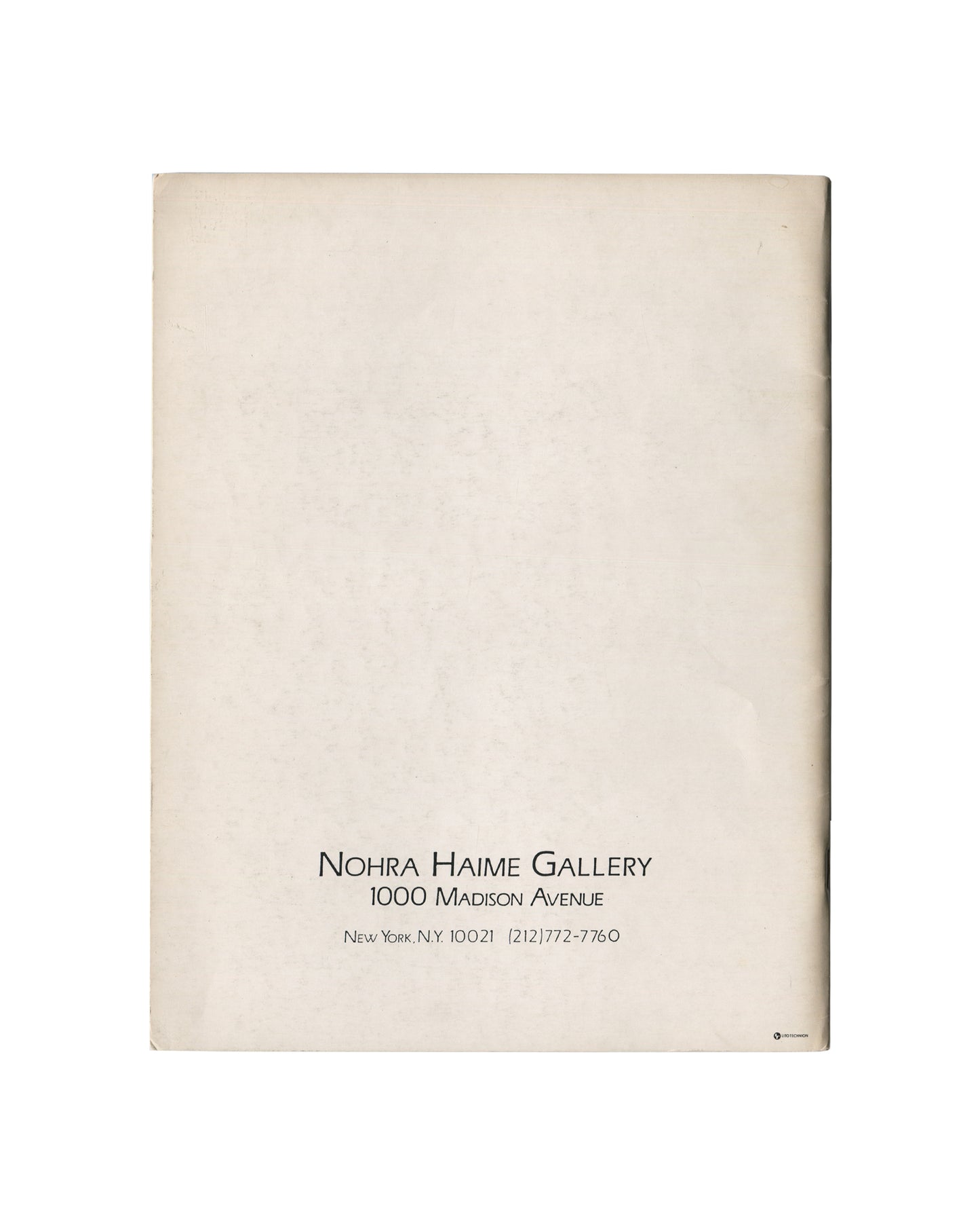 Reverse of c.1985 Constructures: New Perimetrics in Abstract Painting exhibition catalogue showing plain cream-white matte stock with warm age toning and light surface marks, with small centred black serif and small-cap typography at lower centre reading 'NOHRA HAIME GALLERY / 1000 Madison Avenue / New York, N.Y. 10021 (212)772-7760'.