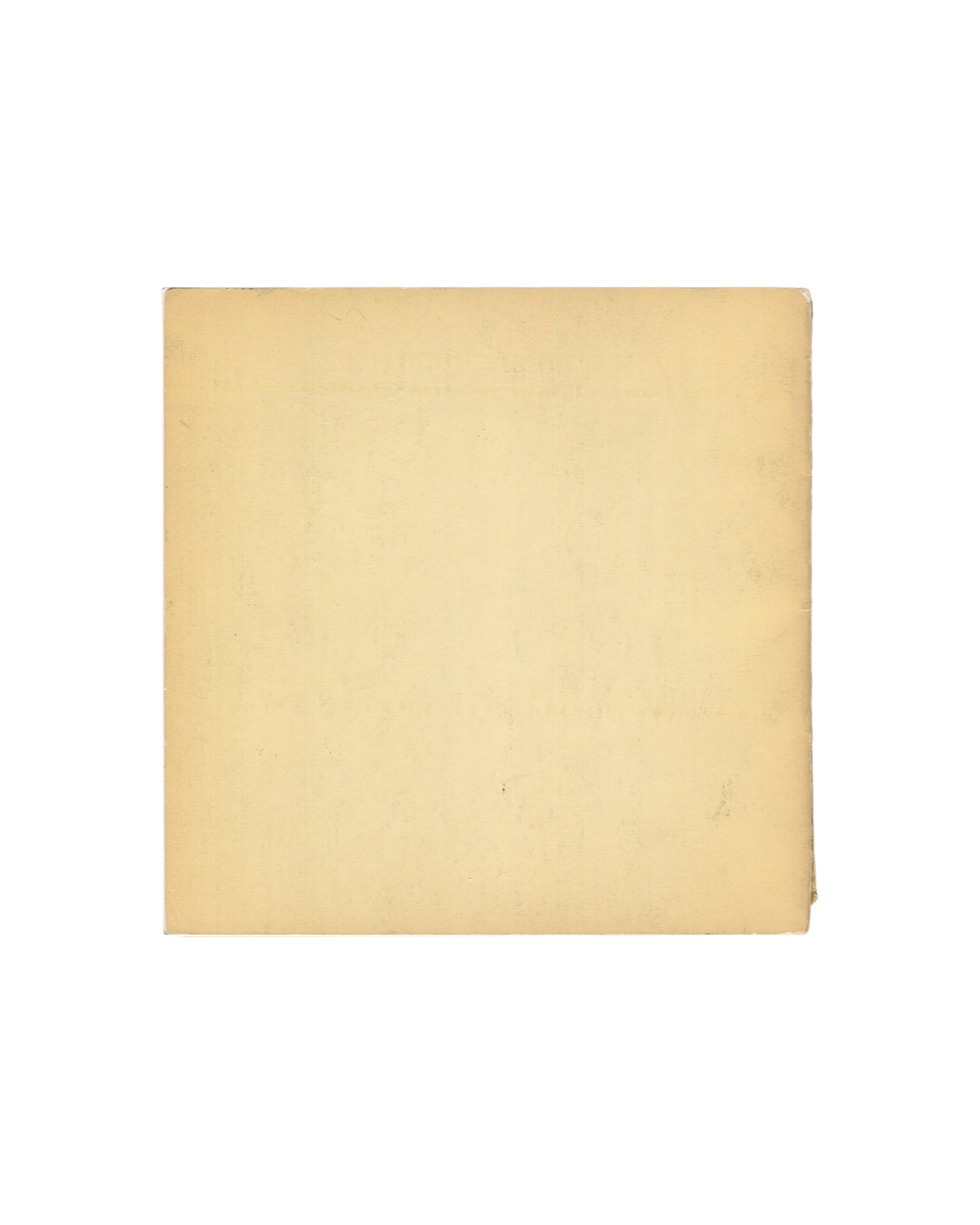 arm cream/yellow back cover, entirely unprinted, showing age toning, light surface marks, and handling wear consistent with period.