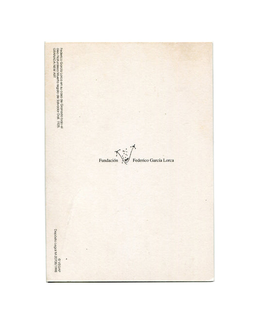 Reverse of Fundación Federico García Lorca postcard c.1998. Cream stock; vertical caption at left edge reading 'Federico García Lorca en su casa de Granada bajo el Óleo Naturaleza Muerta regalo de Salvador Dalí, 1925. GRANADA/NEW ART'; Fundación Federico García Lorca logo and name at centre; '© VEGAP / Depósito Legal M-20708/1998' at lower left.