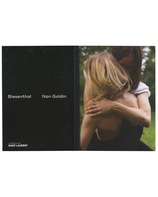 Original 2017 Nan Goldin, Biesenthal, Document Journal in collaboration with Saint Laurent. Cover showing a colour photograph of a partially visible female figure at right — bare torso, sequined mini skirt, holding a cigarette — against a large dark wall with warm ambient light at upper left. No title text on cover; image bleeds to edges.