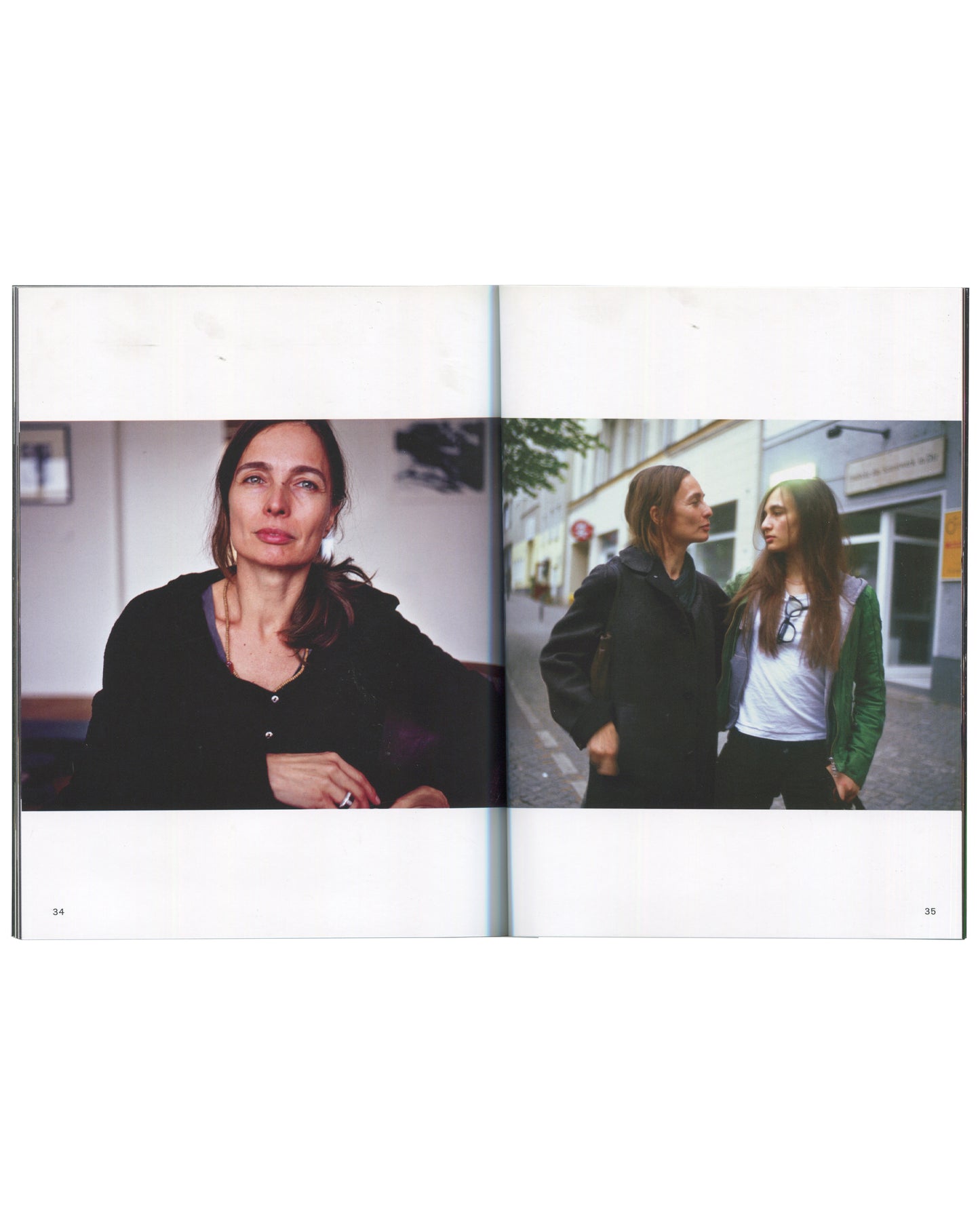 nterior spread from 2017 Nan Goldin, Biesenthal, pages 34–35. Left page: close-up colour portrait of a woman in a black top, hoop earrings, looking slightly upward, shot in a café or interior with soft natural light. Right page: colour street photograph of two young women walking side by side on a Berlin pavement — one in a black jacket, one in a green jacket — looking at each other, shop fronts behind them.