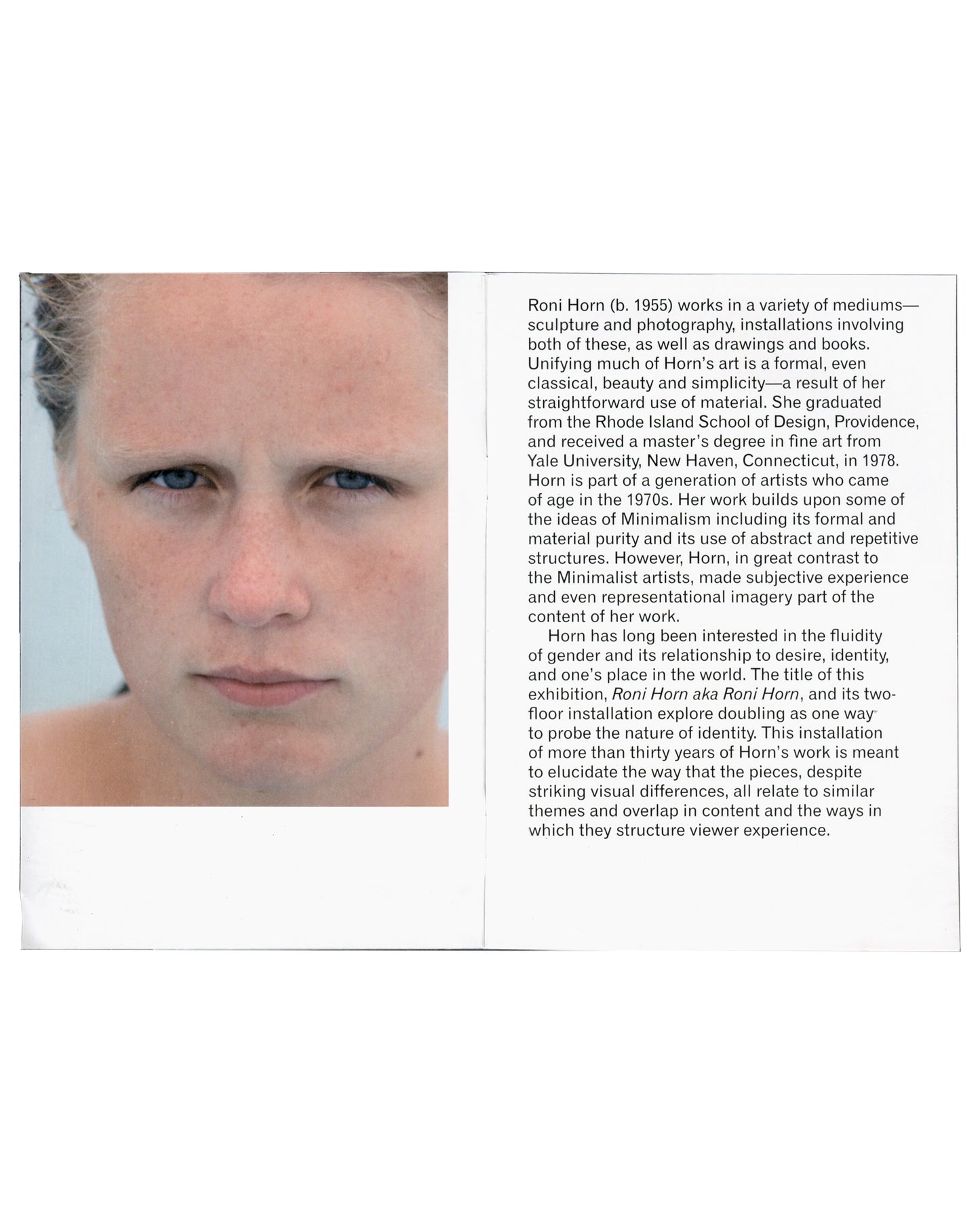Interior spread — biography Roni Horn aka Roni Horn, Whitney Museum of American Art, New York, 2009. Exhibition guide interior spread: left page, colour close-up photograph of a woman's face — pale skin, blue-grey eyes, direct gaze, wet hair pulled back, cropped at forehead and chin — from You Are the Weather; right page, artist biography in small black sans-serif type beginning "Roni Horn (b. 1955) works in a variety of mediums — sculpture and photography, installations involving both of these, as well as