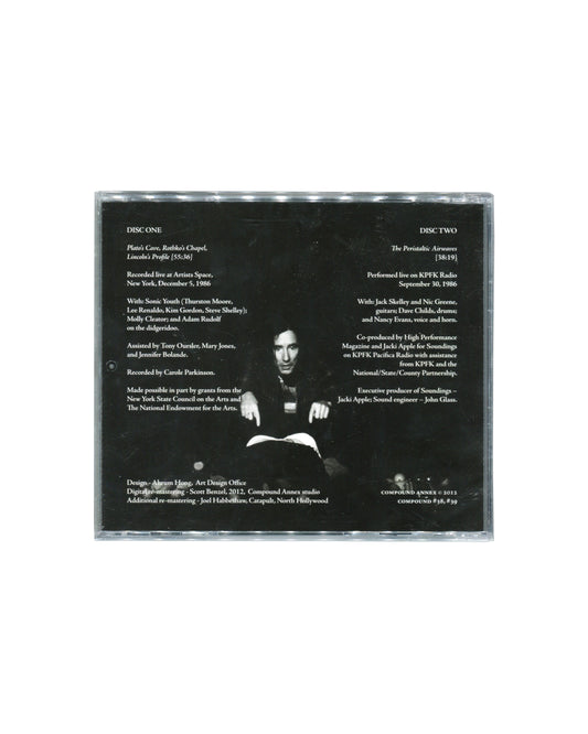 Reverse of sealed Mike Kelley double CD showing track information, recording credits, performance details, and a black-and-white photograph of Kelley. Includes references to Sonic Youth, Artists Space, New York, and KPFK Radio, Los Angeles.
