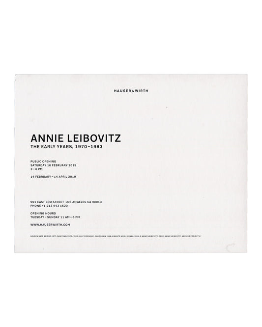 Recto Annie Leibovitz, The Early Years, 1970–1983: Archive Project No. 1, Hauser & Wirth Los Angeles, 2019. Invitation recto: white card; four black and white photographs in a 2×2 grid — top left, view from inside a car approaching the Golden Gate Bridge in fog, 1977; top right, coastal landscape seen through a car window, Half Moon Bay, California, 1968; bottom left, close self-portrait of a woman from the shoulders up, San Francisco, 1968; bottom right, two wooden ladders standing among trees and shrubs,
