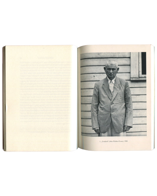 Interior spread from Sherrie Levine, Galerie nächst St. Stephan, Vienna, 1988, left page blank, right page showing a black-and-white reproduction of Untitled (After Walker Evans), 1981, depicting an elderly man in a light suit standing before a clapboard wall, captioned "1. „Untitled" (After Walker Evans), 1981."