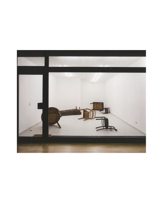 Gregor Schneider, Double, 2011, interior, gallery through dark frame, scattered dark wooden furniture pieces on white floor