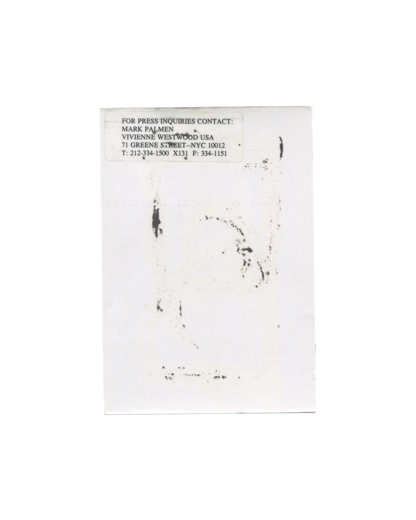 Vivienne Westwood MAN Autumn/Winter 2000–2001 show announcement, reverse, white card with a faint offset ink transfer of the front image visible through the paper; at upper left a typed press contact label reading FOR PRESS INQUIRIES CONTACT: / MARK PALMEN / VIVIENNE WESTWOOD USA / 71 GREENE STREET–NYC 10012 / T: 212-334-1500 X131 F: 334-1151.