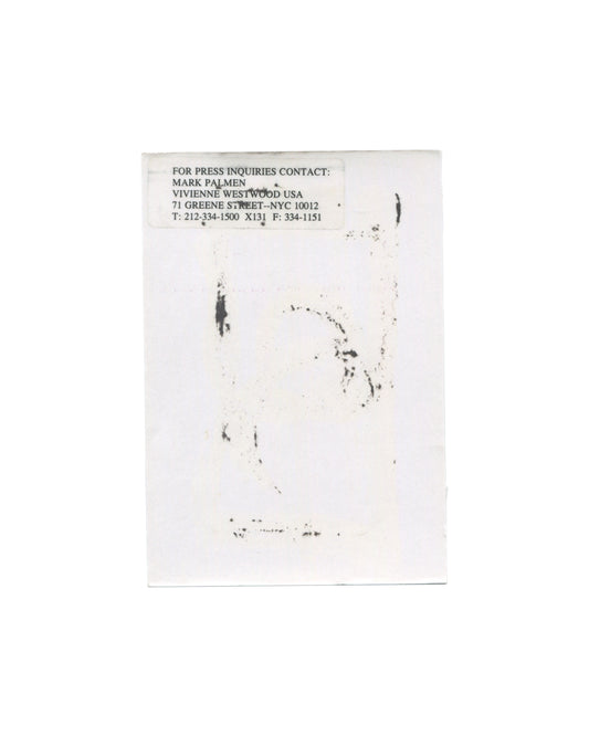 Vivienne Westwood MAN Autumn/Winter 2000–2001 show announcement, reverse, white card with a faint offset ink transfer of the front image visible through the paper; at upper left a typed press contact label reading FOR PRESS INQUIRIES CONTACT: / MARK PALMEN / VIVIENNE WESTWOOD USA / 71 GREENE STREET–NYC 10012 / T: 212-334-1500 X131 F: 334-1151.
