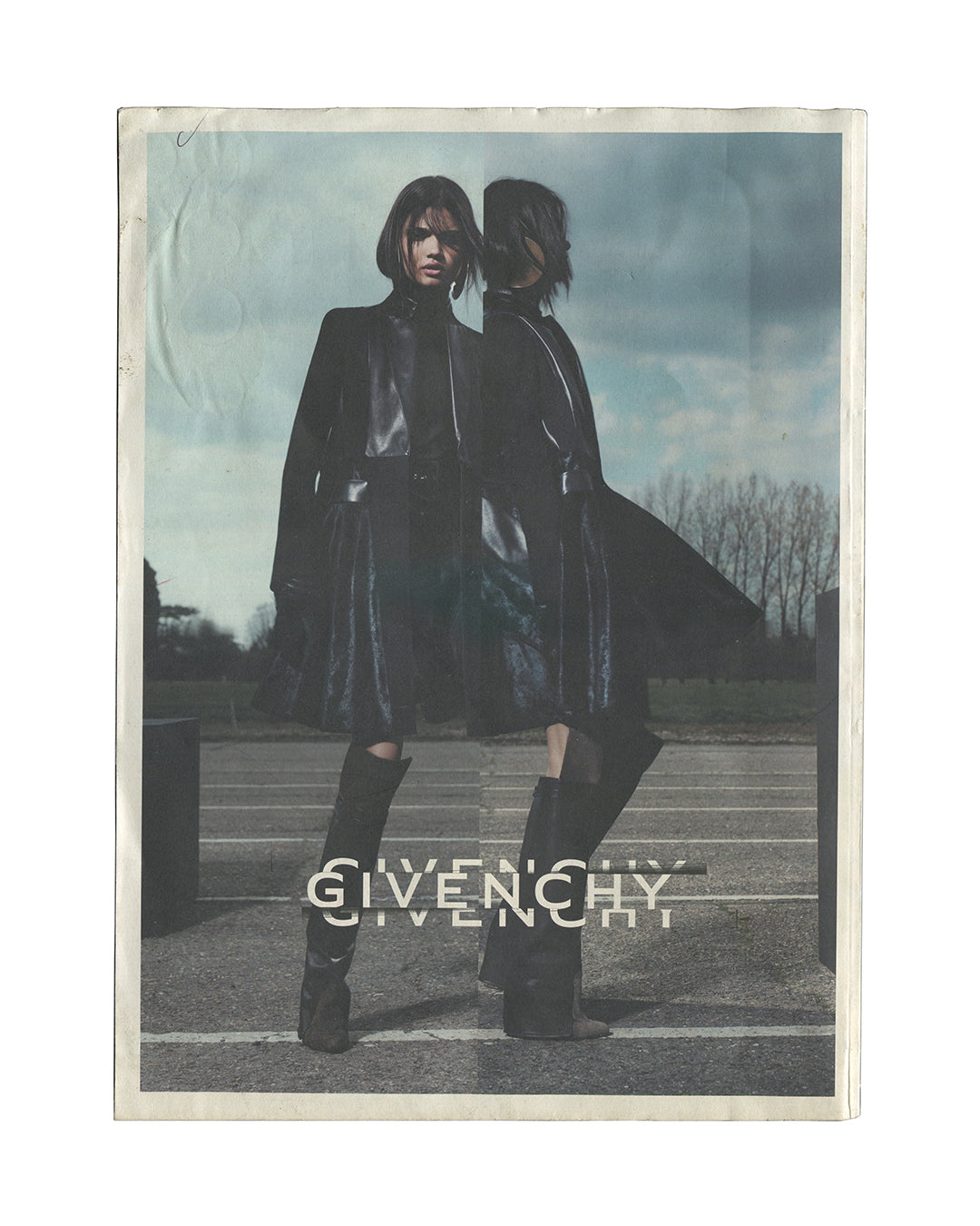 Reverse of 2012 Acne Paper No. 14 magazine showing back cover with Givenchy fashion advertisement featuring a model in a dark coat, with the Givenchy logotype repeated in white.