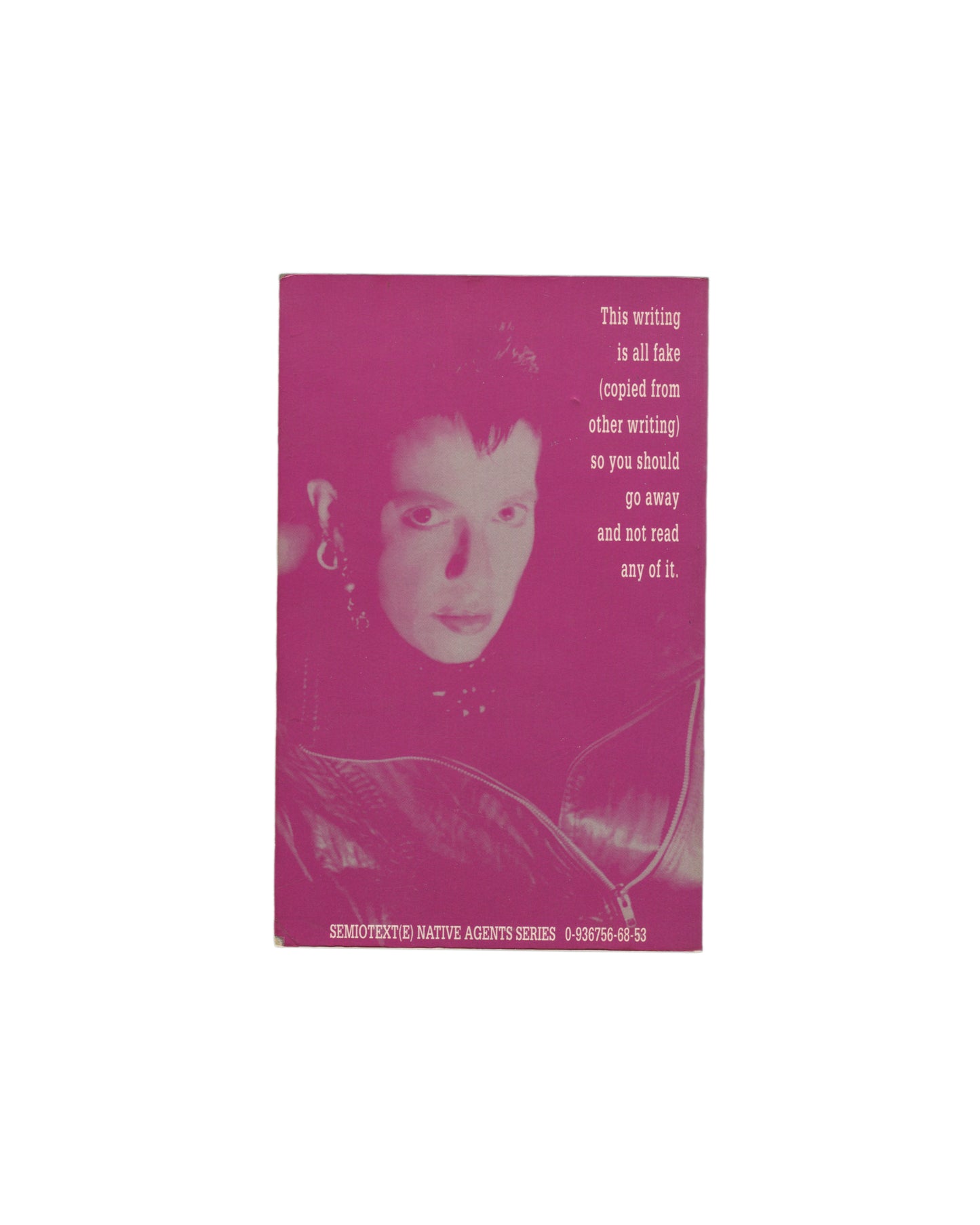 Reverse of 1991 Kathy Acker Hannibal Lecter, My Father paperback, Semiotext(e) Native Agents Series. Back cover in magenta-pink showing a halftone portrait photograph of Acker and the text: This writing is all fake (copied from other writing) so you should go away and not read any of it. ISBN and series imprint at foot.