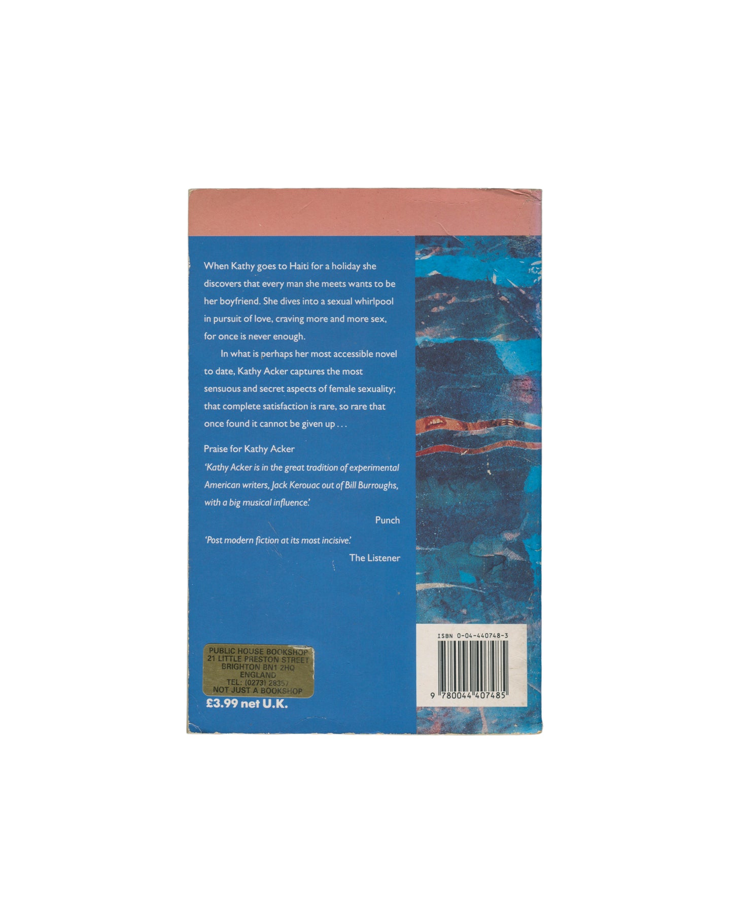 The back cover of the Kathy Acker book, Kathy Goes to Haiti shown against a plain white background. The cover features a solid blue lower section with a quote, a barcode, and a textured abstract blue and orange pattern on the right side.