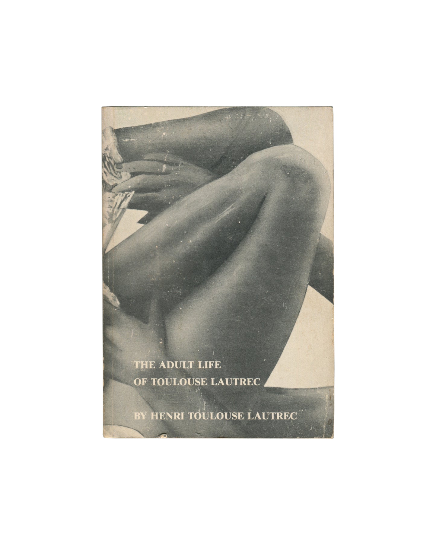 Original 1978 Kathy Acker The Adult Life of Toulouse Lautrec by Henri Toulouse Lautrec paperback, TVRT Press and Printed Matter, New York. Front cover with black-and-white photographic image of two pairs of legs, one in stockings raised in the air, the other bare and low. Title in lowercase serif type: all she wants is love... Publisher imprints PM and TVRT Press at foot with ISBN 0-931106-21-4. Original price $4.50 at top left. Covers with age toning and surface wear.