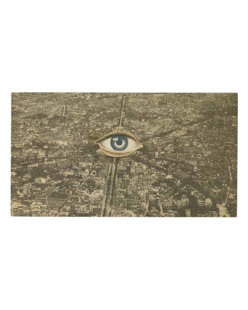 Original 1990 Collages Surréalistes exhibition invitation, Galerie Zabriskie, Paris — cover reproducing Georges Hugnet, Le Sphinx du Moulin Vert, 1934: aerial black-and-white photograph of Paris with radiating boulevards, a single realistic eye with lashes montaged at centre.