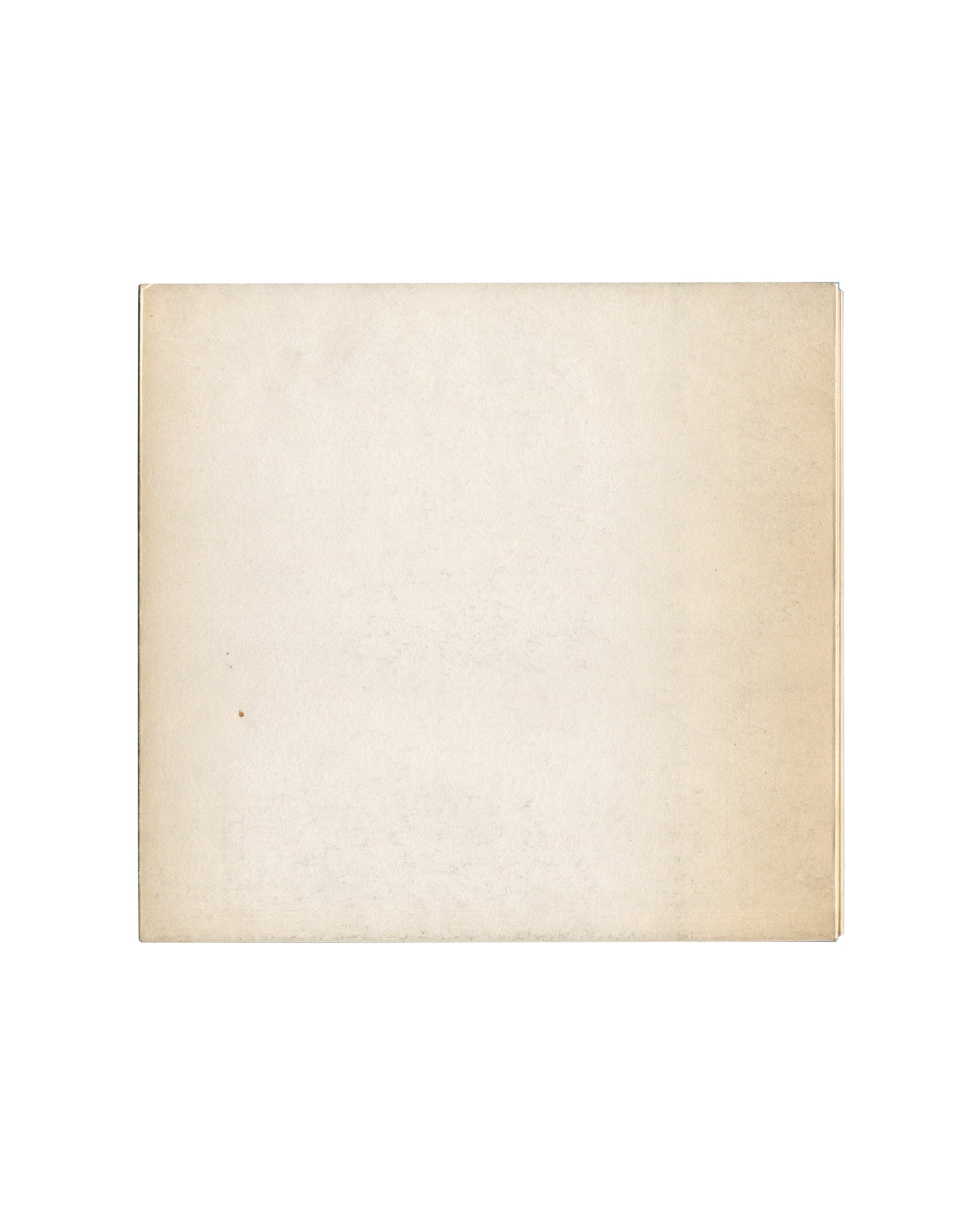 Reverse of c.1966 Seul, et le corps… Galerie du Dragon Paris exhibition catalogue showing plain cream-white matte stock with uniform warm age toning, light surface marks, and softened edges consistent with archive storage and period gallery circulation.