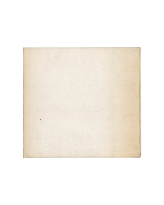 Reverse of c.1966 Seul, et le corps… Galerie du Dragon Paris exhibition catalogue showing plain cream-white matte stock with uniform warm age toning, light surface marks, and softened edges consistent with archive storage and period gallery circulation.