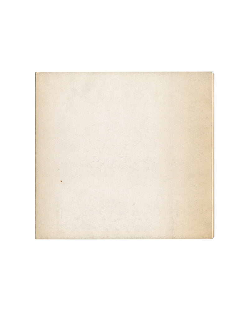 Reverse of c.1966 Seul, et le corps… Galerie du Dragon Paris exhibition catalogue showing plain cream-white matte stock with uniform warm age toning, light surface marks, and softened edges consistent with archive storage and period gallery circulation.