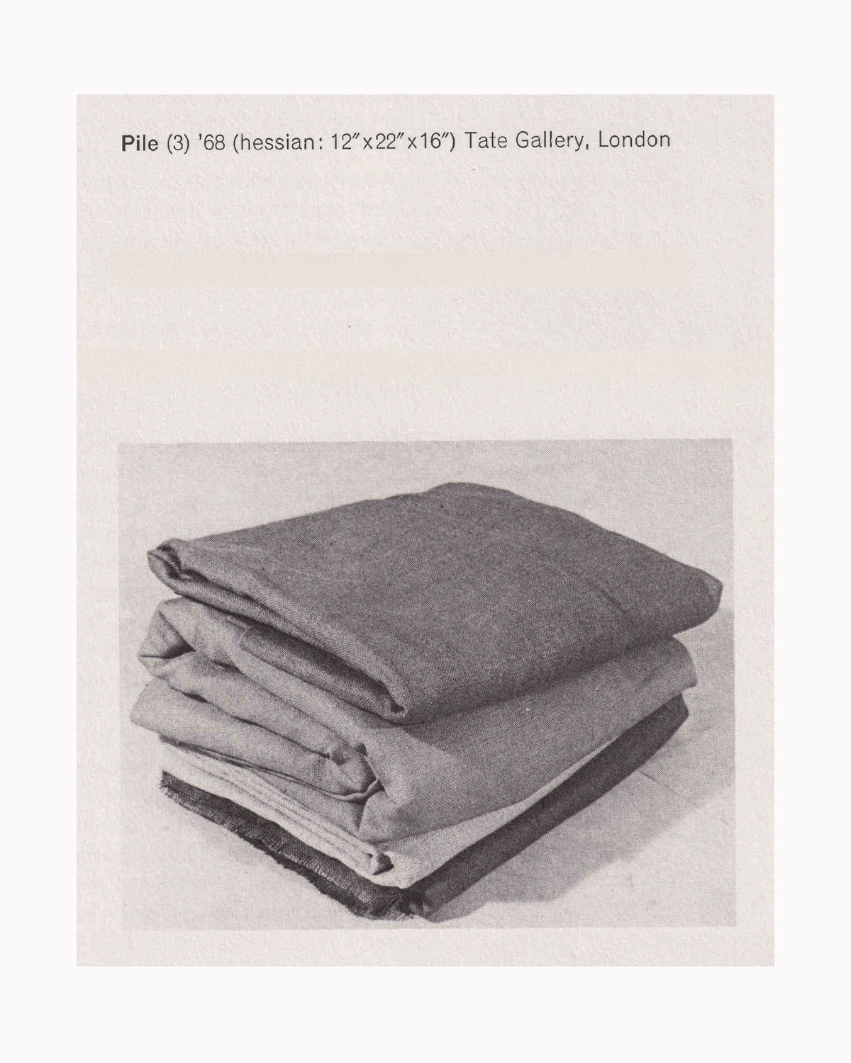 Barry Flanagan, Pile (3), 1968 — hessian, 12" x 22" x 16" — black and white catalogue photograph showing four folded hessian sheets stacked on the floor, Tate Gallery, London — reproduced in Sculptures 1966–1976, Van Abbemuseum, 1977