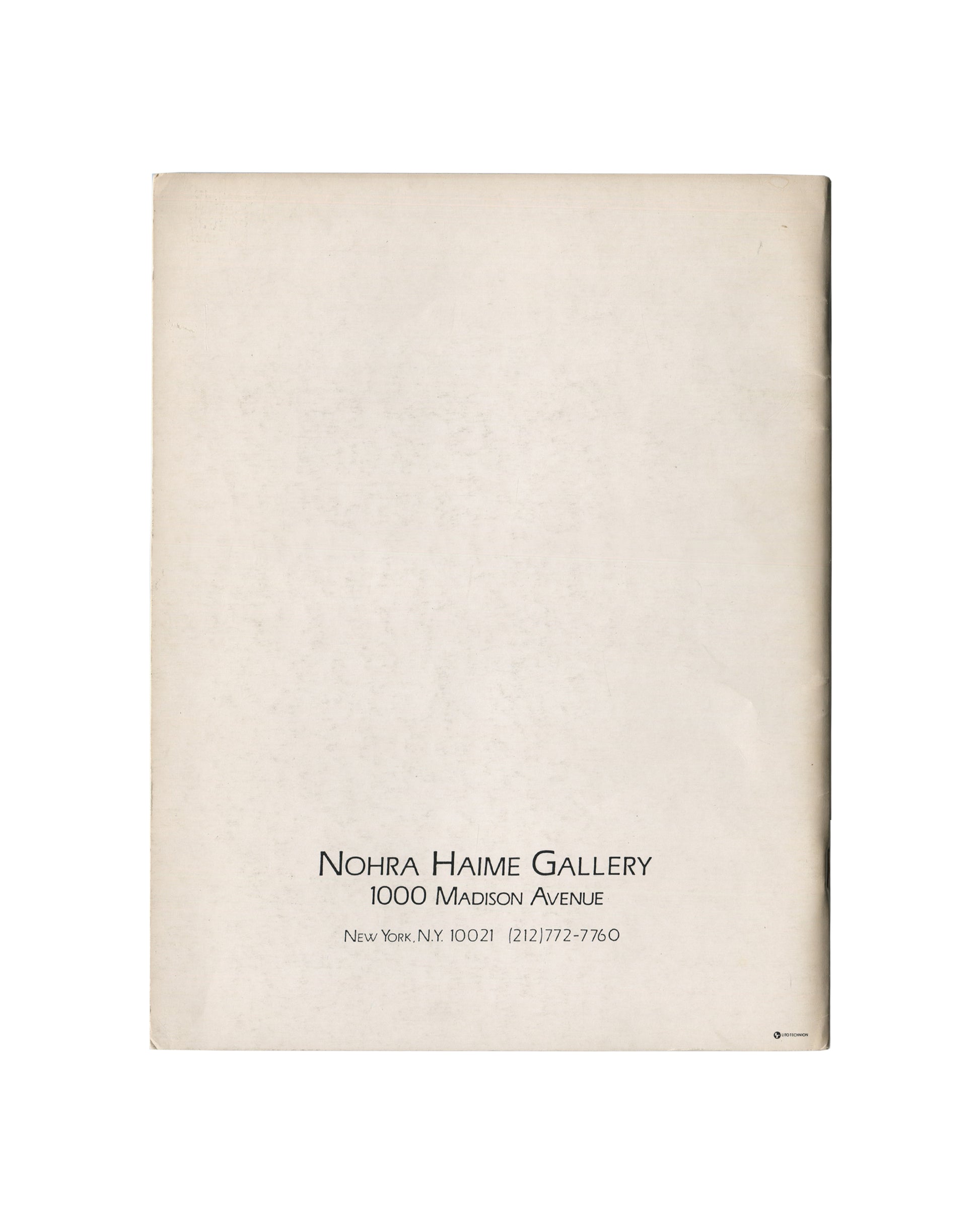 Reverse of c.1985 Constructures: New Perimetrics in Abstract Painting exhibition catalogue showing plain cream-white matte stock with warm age toning and light surface marks, with small centred black serif and small-cap typography at lower centre reading 'NOHRA HAIME GALLERY / 1000 Madison Avenue / New York, N.Y. 10021 (212)772-7760'.
