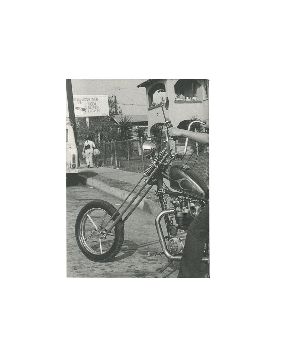  Reverse of 2011 Janette Beckman El Hoyo Maravilla, Dashwood Books. Back cover showing near-blank white wrapper with small inset black-and-white photograph of a chopper motorcycle parked on a suburban street with a Kool cigarettes billboard visible behind.