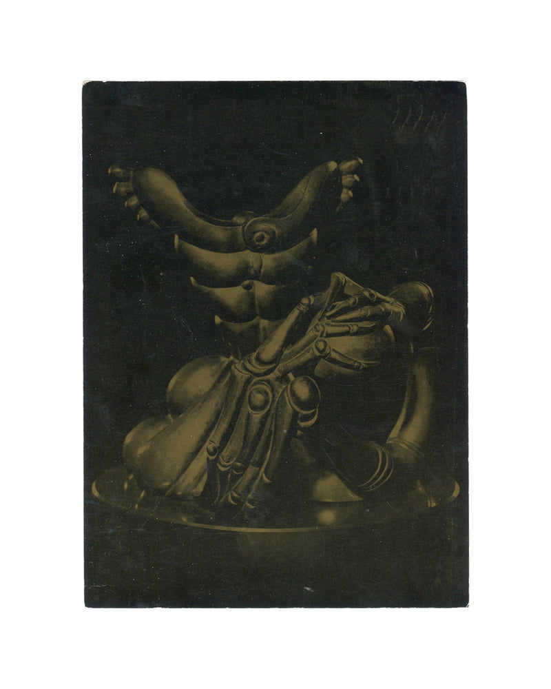 Original 1972 Hans Bellmer New Year postcard, Galerie Suzanne Visat, Paris — recto reproducing Bellmer's Les mains immobiles, 1971: dark-ground photographic image of a bronze sculpture showing a crouching figure with multiple articulated mechanical arms and hands, cast by Ateliers Godard in an edition of 21, height 28 cm. Surface rubbing and scuffing consistent with postal handling.