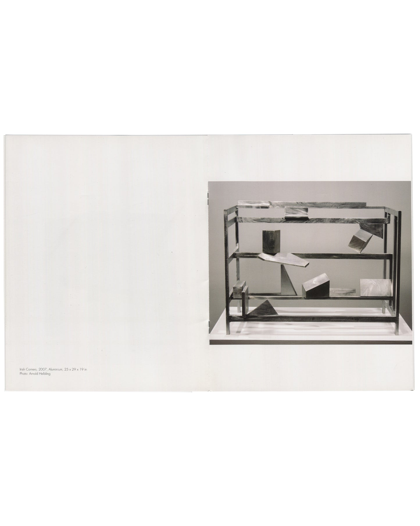 Willard Boepple, New Sculpture, Broadbent Gallery, London, 2008. Interior spread: left, white page blank; right, black-and-white photograph of Irish Corners (2007), aluminium, 25 × 29 × 19 in — open shelf framework with angled plates, irregular blocks and geometric forms suspended at varying heights. Caption lower left, photo credit Arnold Helbling.