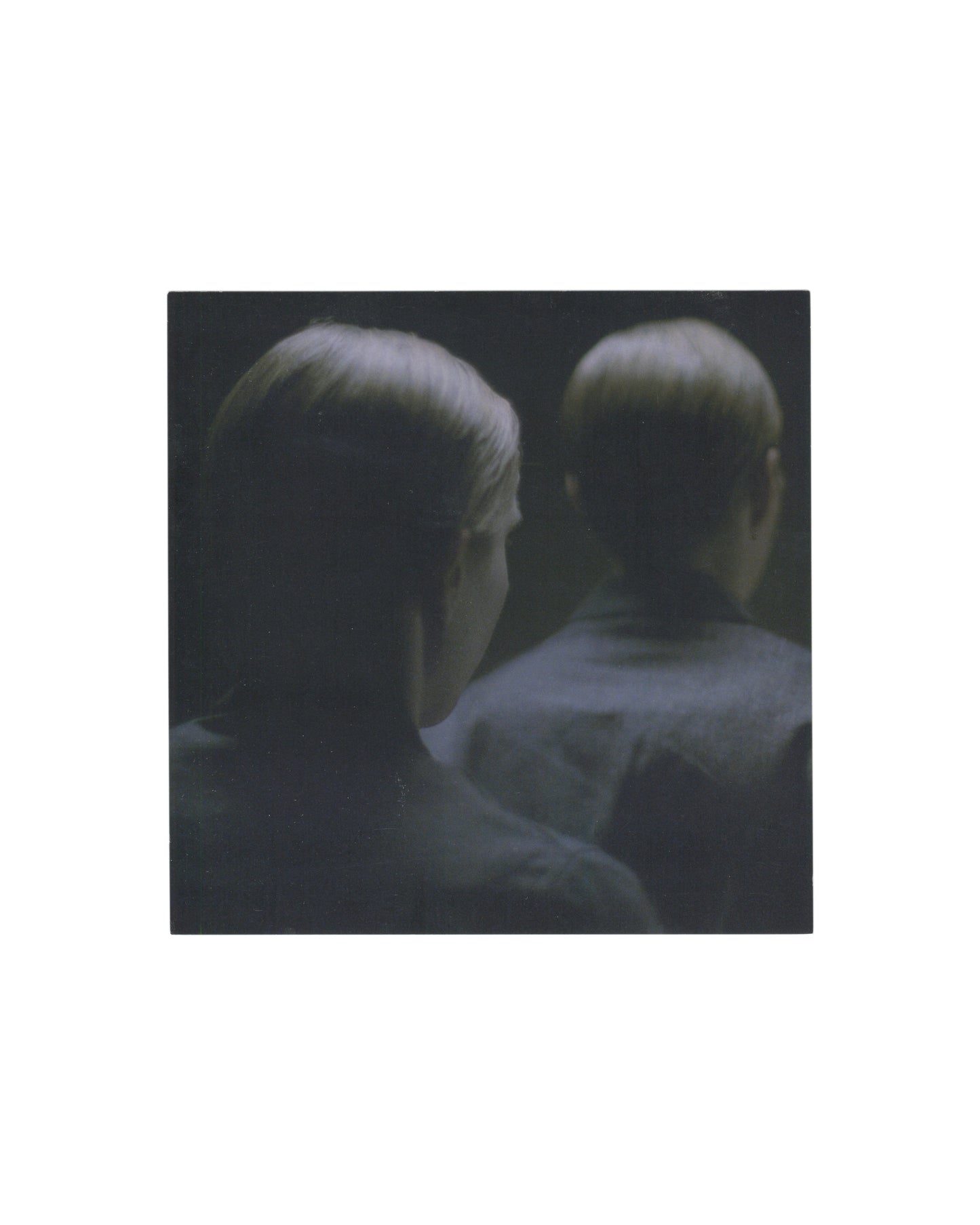 Reverse of 2009 Michaël Borremans Taking Turns David Zwirner New York exhibition invitation card showing pale cream-white ground with small caption at upper right in light grey serif type reading 'Taking Turns, 2009 (film still) / 35mm film transferred to DVD'; centred lower half with 'Michaël Borremans' in large light serif type, 'Taking Turns' in smaller italic below, exhibition dates 'February 24 through / March 25, 2009', reception 'February 24, 2009, 6 to 8 pm', and 'David Zwirner' in bold serif with a