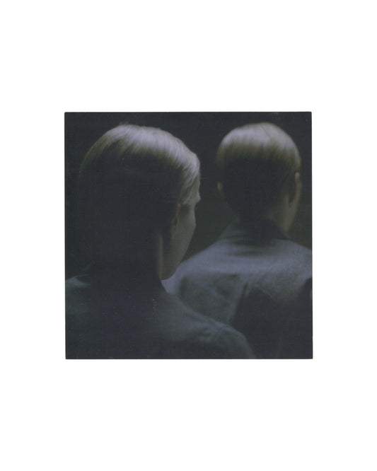 Reverse of 2009 Michaël Borremans Taking Turns David Zwirner New York exhibition invitation card showing pale cream-white ground with small caption at upper right in light grey serif type reading 'Taking Turns, 2009 (film still) / 35mm film transferred to DVD'; centred lower half with 'Michaël Borremans' in large light serif type, 'Taking Turns' in smaller italic below, exhibition dates 'February 24 through / March 25, 2009', reception 'February 24, 2009, 6 to 8 pm', and 'David Zwirner' in bold serif with a