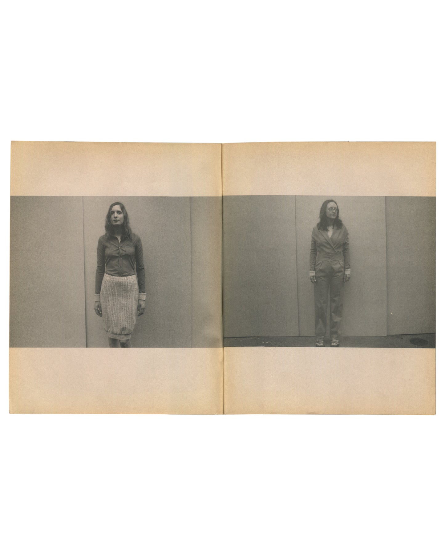 nterior spread of c. 2002 Mark Borthwick Social Documentaries Amid this Piste, self-published photocopy edition. Double-page spread showing two grayscale Xerox photographs of a woman standing facing the camera against a plain studio wall: left image showing her in a dark zip-up top and a pale pleated midi skirt with white cuffs or wristbands; right image showing the same woman in a dark belted jacket and trousers with white cuffs, standing slightly further from the wall. Both images printed as horizontal ba
