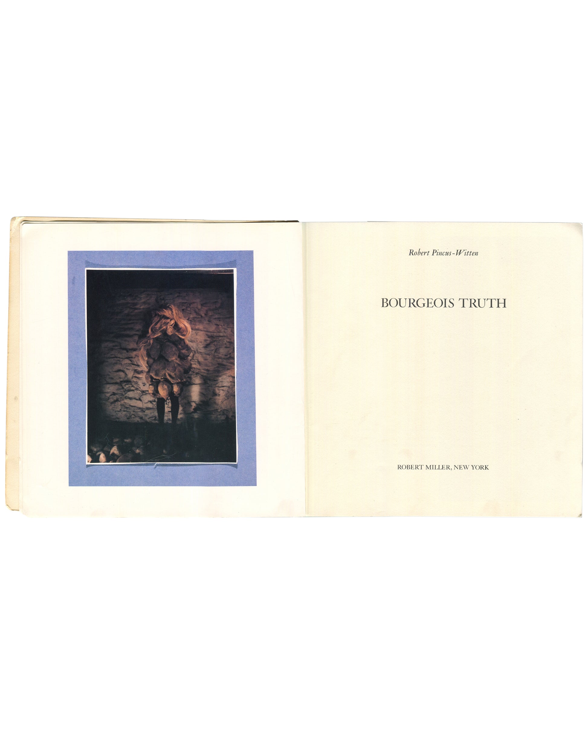 Interior spread of 1982 Louise Bourgeois Bourgeois Truth — left page with colour photograph of a small figure in a fur coat standing against a stone wall in dim light, mounted on blue-grey card; right page with title page reading Robert Pincus-Witten / BOURGEOIS TRUTH / Robert Miller, New York in serif type