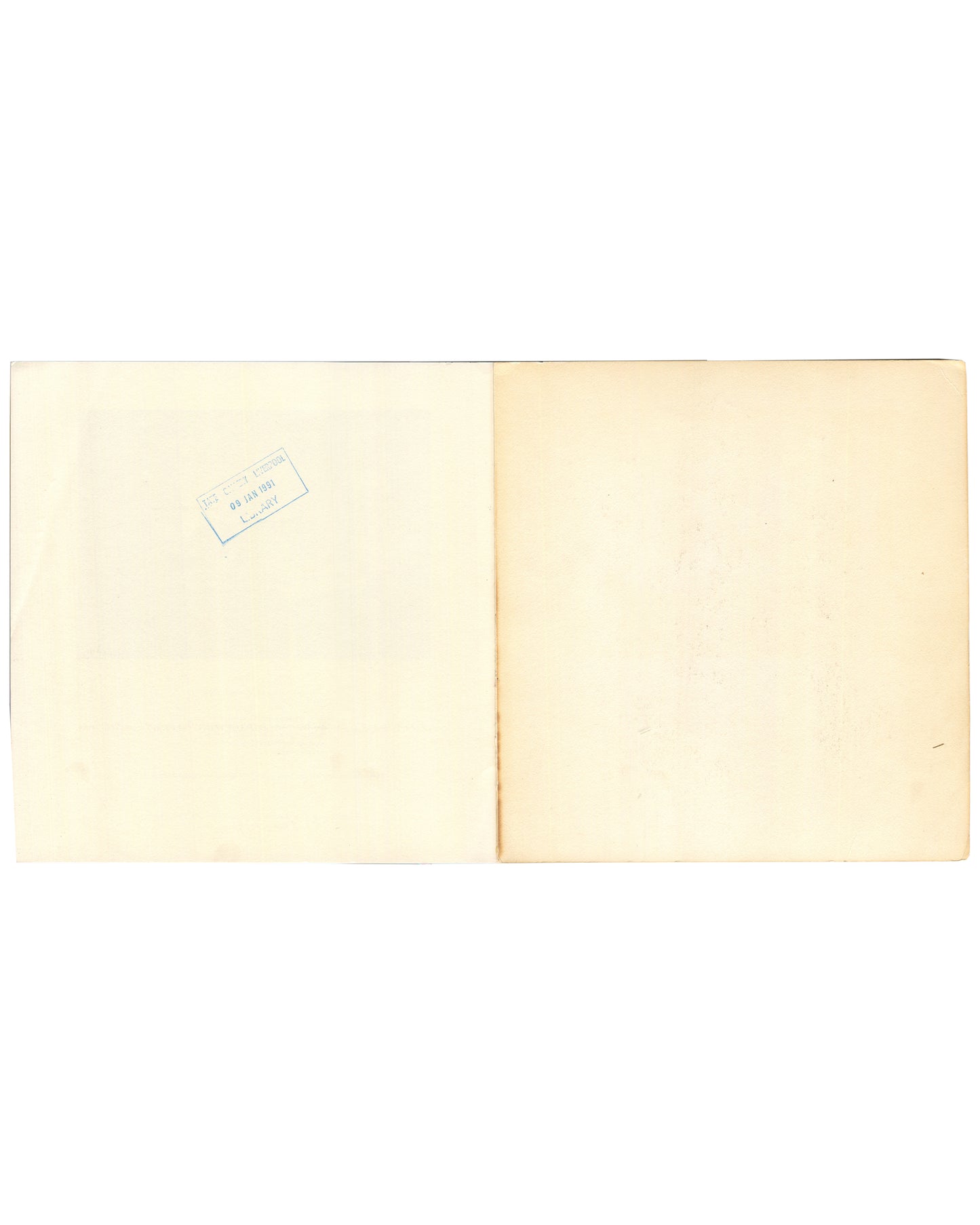 Interior rear endpaper spread of 1982 Louise Bourgeois Bourgeois Truth — both pages blank cream with age toning; small rectangular library accession stamp visible at upper left of left page