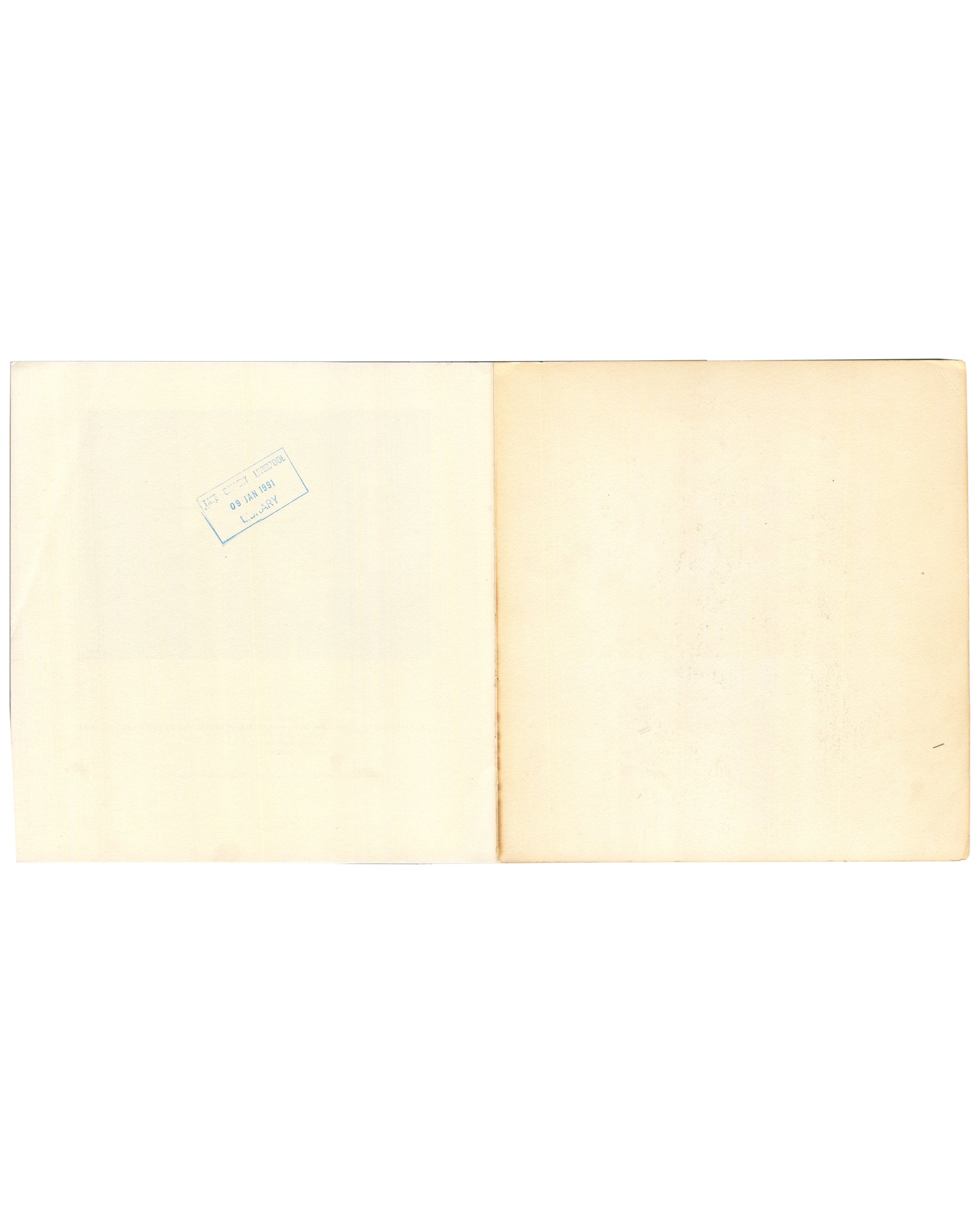 Interior rear endpaper spread of 1982 Louise Bourgeois Bourgeois Truth — both pages blank cream with age toning; small rectangular library accession stamp visible at upper left of left page