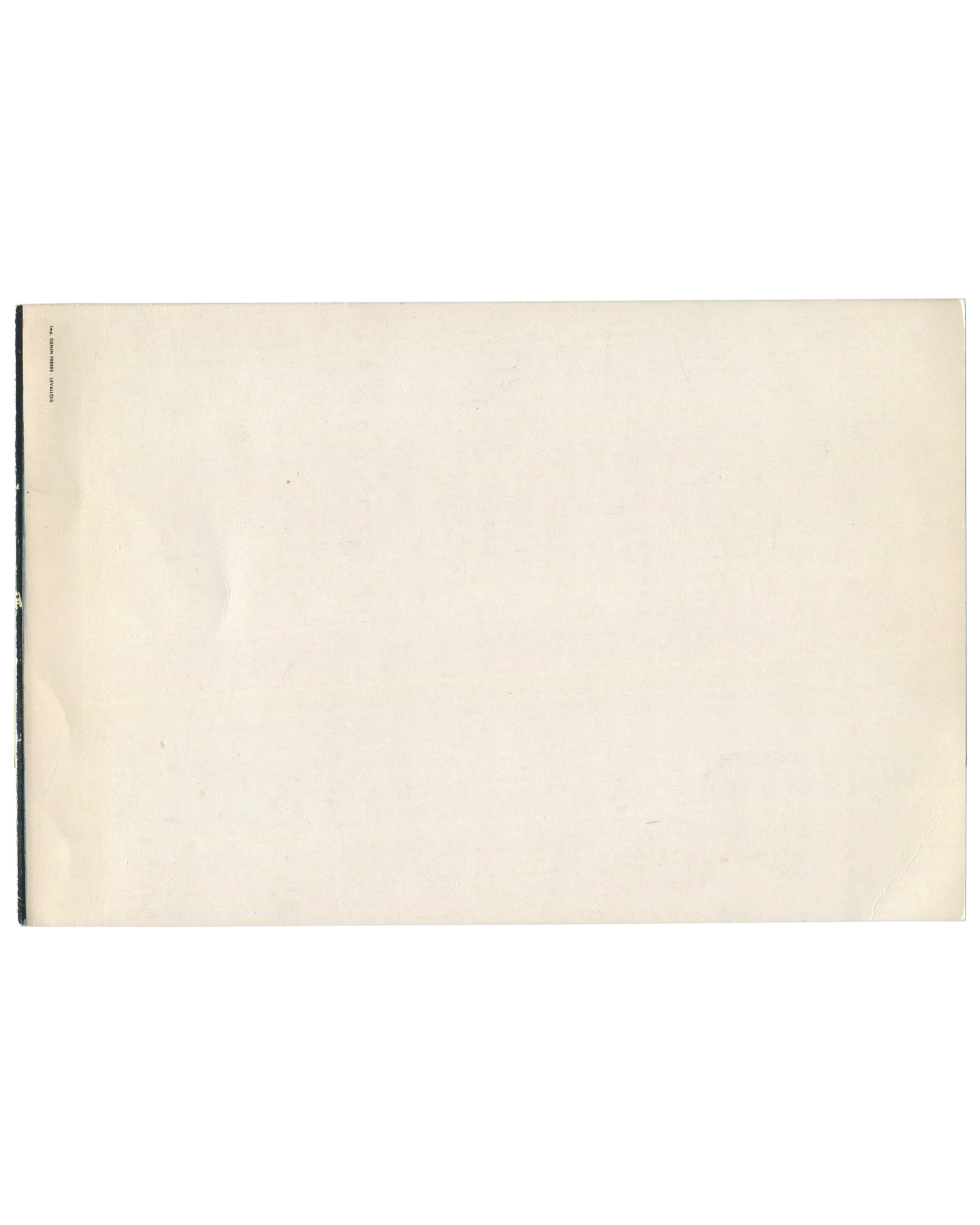Reverse of c.1960s Madeleine Alain Brieux Collages Galerie du Passeur Paris exhibition invitation card showing near-blank cream-white card stock with warm age toning, light surface marks, and faint vertical fold line at left; small black text at far left edge reading 'IMPRIMERIE FIRMIN-DIDOT' in tiny type; staple binding visible at le