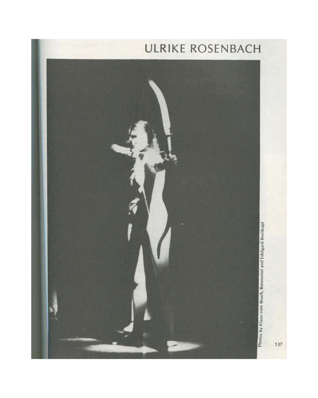 Interior page from 1979 Performance by Artists, Art Metropole, page 137. Black-and-white photograph of Ulrike Rosenbach in performance, figure in dramatic spotlight holding a large curved blade above her head, photos credited to Klaus vom Bruch, Rosenstiel and Edelgard Breitkopf.