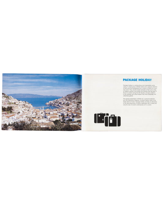Package Holiday, Hydra Workshop, 1997. Interior spread: left, full-bleed colour photograph of Hydra harbour and hillside town — whitewashed cubic buildings descending to the water, blue sky and sea; right, white page with "PACKAGE HOLIDAY" heading in bold blue type, two paragraphs of exhibition text, and black silhouette of three stacked suitcases lower centre.
