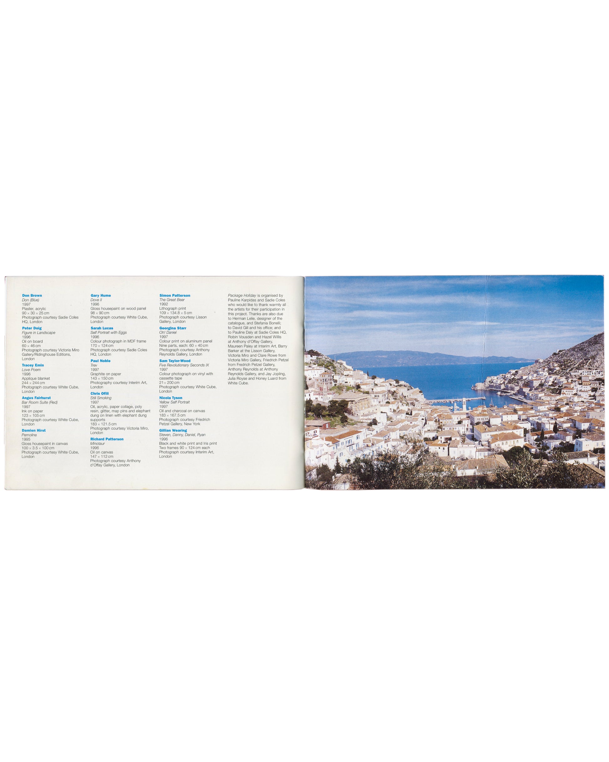 Package Holiday, Hydra Workshop, 1997. Interior checklist spread: left, two-column artist checklist in small type listing all 15 artists with works, media, dimensions and photo credits — organised by Pauline Karpidas and Sadie Coles, acknowledgements column right; right, full-bleed colour photograph of Hydra harbour with whitewashed cubic buildings rising on the hillside under a clear blue sky.