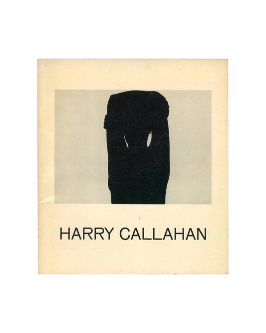 Original 1967 Harry Callahan exhibition catalogue, Museum of Modern Art, New York. Cream softcover with a black-and-white photograph of a standing female figure seen from behind, torso bare, seated on a stool before a window with venetian blinds, interior domestic space visible around her. 'HARRY CALLAHAN' in sans-serif type below the image.