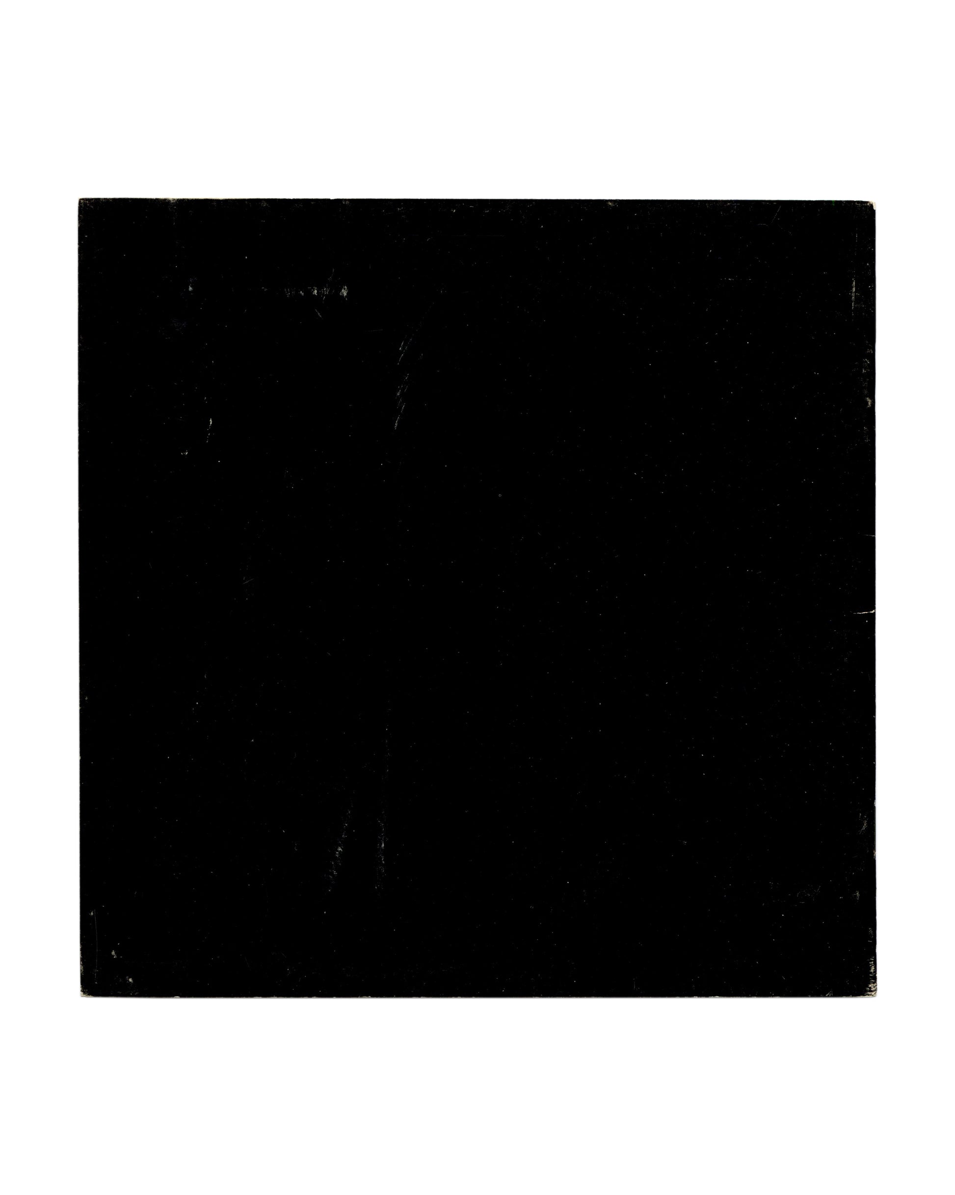  Back cover showing solid black ground with pronounced rubbing, scratching and edge wear consistent with vintage handling and circulation.