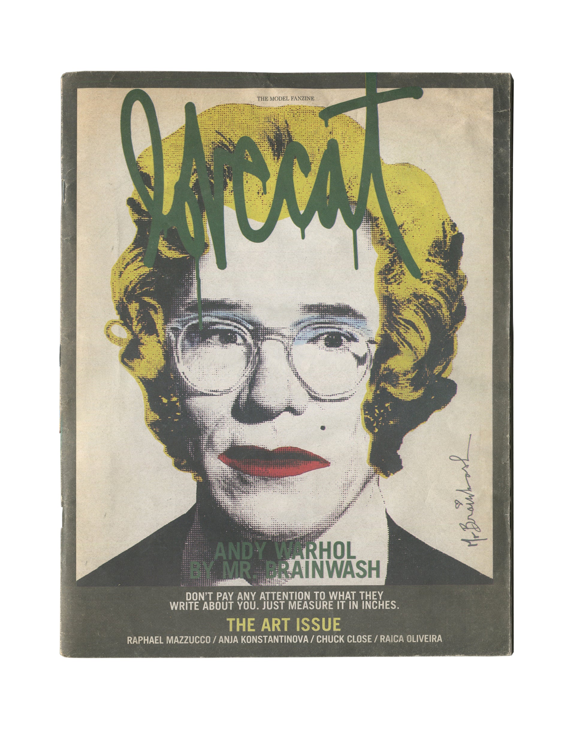 Second cover variant of 2012 Lovecat: The Model Fanzine, Issue 3, The Art Issue. Large black-and-white halftone portrait of Andy Warhol with yellow hair and red lips, overlaid with dark green graffiti-style 'lovecat' lettering and Mr. Brainwash signature at lower right. Caption reads 'ANDY WARHOL BY MR. BRAINWASH / THE ART ISSUE / DON'T PAY ANY ATTENTION TO WHAT THEY WRITE ABOUT YOU. JUST MEASURE IT IN INCHES.' Contributors listed: Raphael Mazzucco, Anja Konstantinova, Chuck Close, Raica Oliveira.