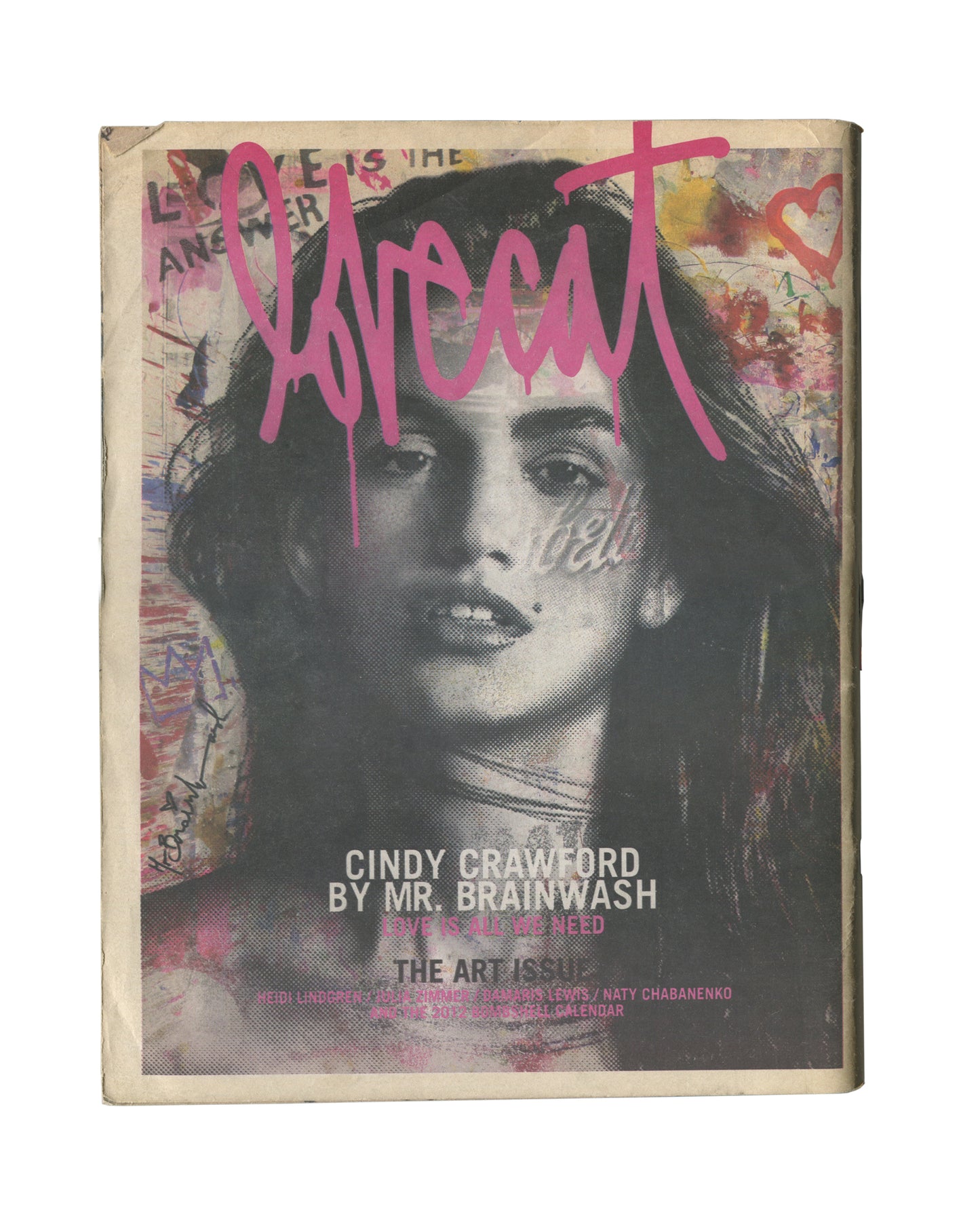 Original 2012 Lovecat: The Model Fanzine, Issue 3, The Art Issue, New York. Cover showing a large black-and-white halftone portrait of Cindy Crawford overlaid with pink graffiti-style 'lovecat' lettering, pink heart, and handwritten text reading 'Love is the Answer'. Caption reads 'CINDY CRAWFORD BY MR. BRAINWASH / THE ART ISSUE'. General handling wear and edge wear consistent with period fanzine.