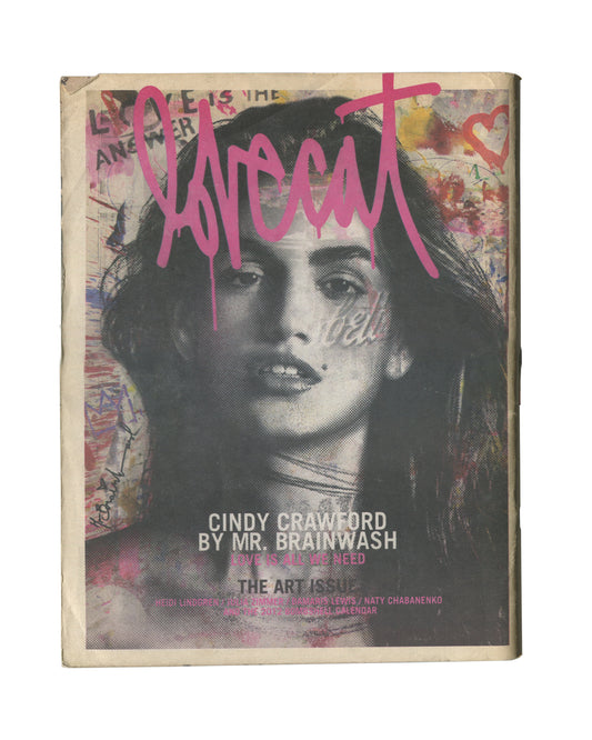 Original 2012 Lovecat: The Model Fanzine, Issue 3, The Art Issue, New York. Cover showing a large black-and-white halftone portrait of Cindy Crawford overlaid with pink graffiti-style 'lovecat' lettering, pink heart, and handwritten text reading 'Love is the Answer'. Caption reads 'CINDY CRAWFORD BY MR. BRAINWASH / THE ART ISSUE'. General handling wear and edge wear consistent with period fanzine.
