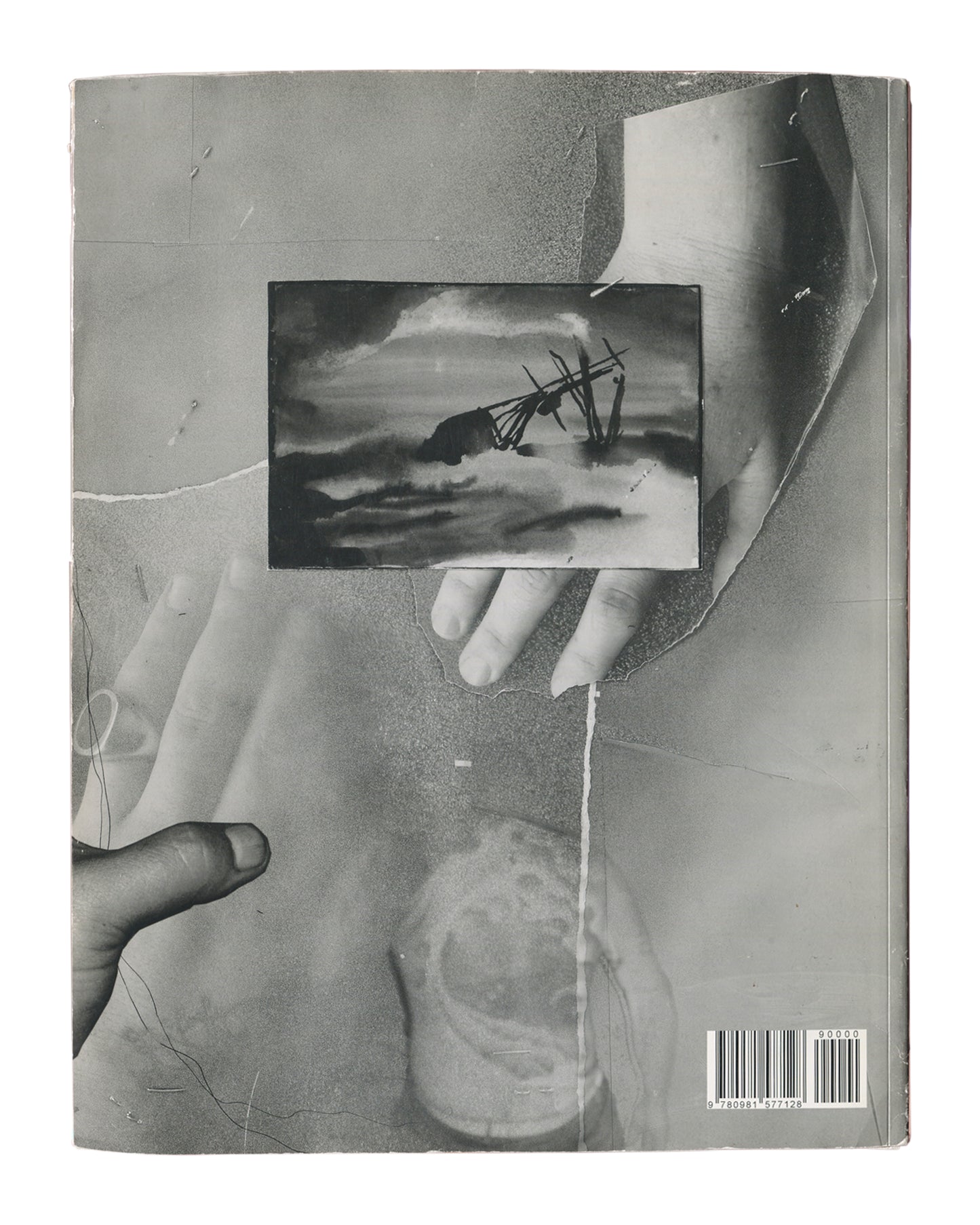 Black-and-white photographic collage of two hands holding a small landscape reproduction, layered over torn paper and circular stain. ISBN 9780981577128 at lower right.