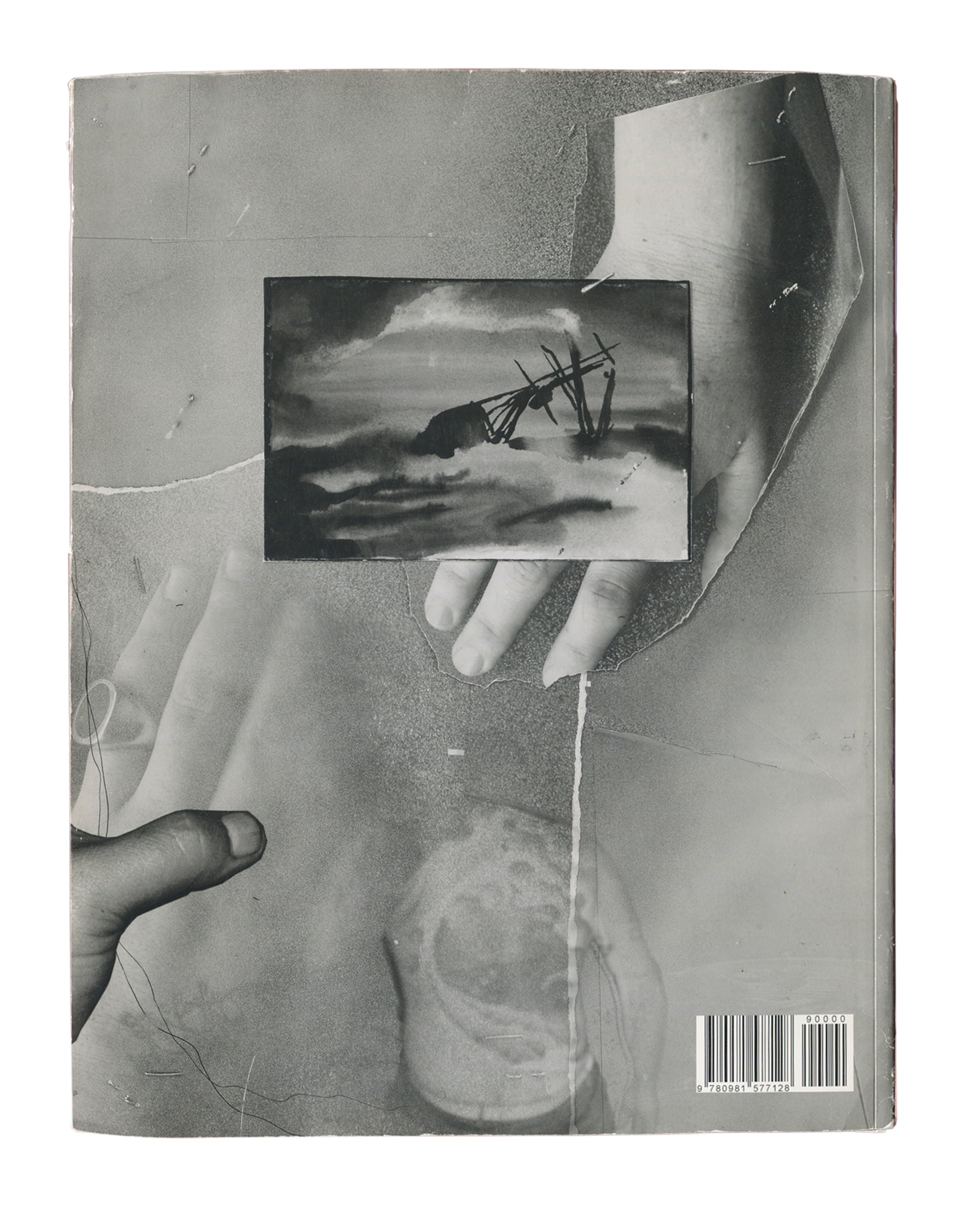 Black-and-white photographic collage of two hands holding a small landscape reproduction, layered over torn paper and circular stain. ISBN 9780981577128 at lower right.