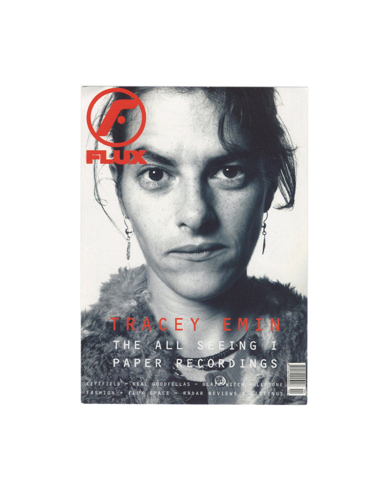 Tracey Emin, FLUX Magazine promotional postcard recto, c. 1999. Black-and-white close-up portrait photograph of Tracey Emin: direct gaze, dark eyes, short dark hair pulled back, wearing a fur-collared or textured jacket, small drop earrings. Red circular FLUX logo upper left with 'FLUX' in bold red sans-serif type. Red text below: 'TRACEY EMIN / THE ALL SEEING I / PAPER RECORDINGS'. Smaller red text at foot lists additional features: 'LEFTFIELD – REAL GOODFELLAS – BLAIR WITCH – LE TONE / FASHION – FLUX SPAC