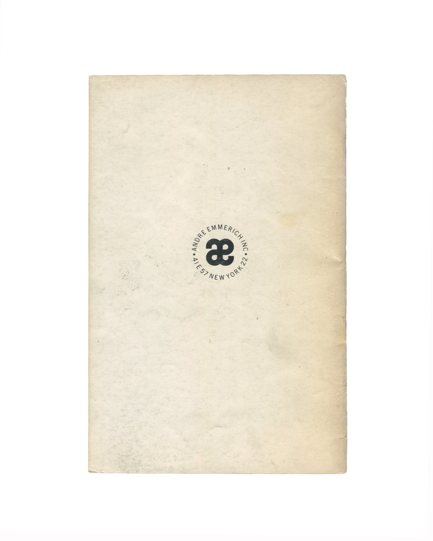 `Animals in Pre-Columbian Art — André Emmerich Inc., New York — back cover. Cream wraps with circular colophon at centre: "æ" ligature monogram surrounded by text reading "ANDRE EMMERICH INC. · 4 LE 57 NEW YORK 22". Age toning and handling wear to surface.`