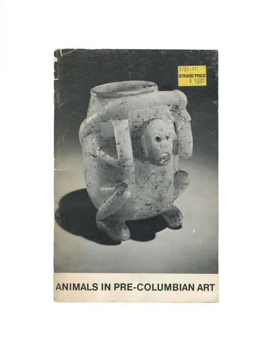 `Animals in Pre-Columbian Art — André Emmerich Gallery, New York — exhibition catalogue front cover. Black and white photograph of a Pre-Columbian ceramic effigy vessel: a squat, four-legged jar with a zoomorphic face — wide-set eyes, open mouth with teeth, and stubby limbs — on a grey ground. Yellow Strand Bookstore price sticker upper right ($15.00). Title in black sans-serif at foot: "ANIMALS IN PRE-COLUMBIAN ART".`