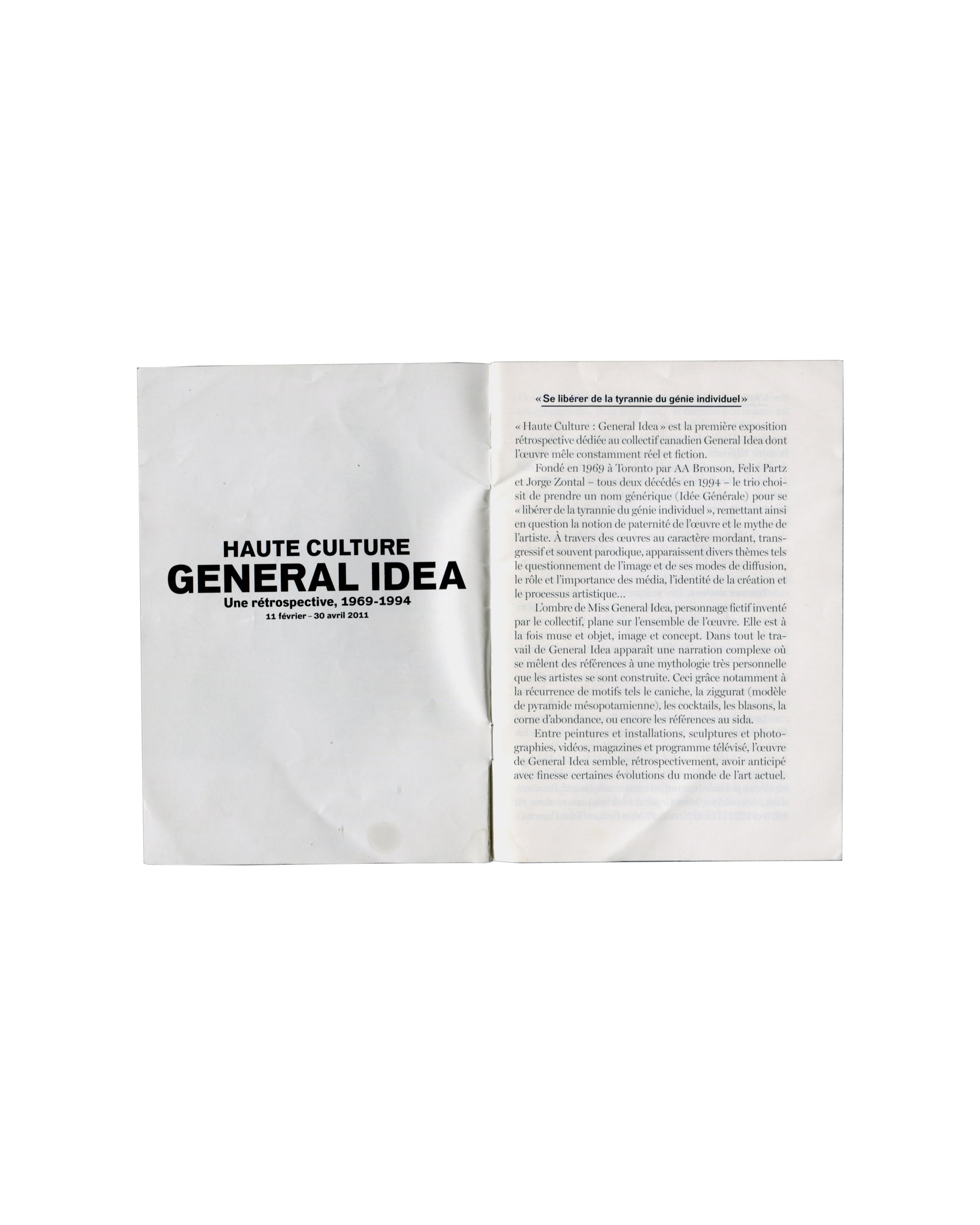 Interior spread General Idea, Haute Culture: Une rétrospective, 1969–1994, Musée d'Art moderne de la Ville de Paris, 2011. Booklet interior spread: left page, exhibition title in large bold black serif — 'HAUTE CULTURE / GENERAL IDEA / Une rétrospective, 1969–1994 / 11 février – 30 avril 2011' on white ground; right page, pull quote in italic — '«Se libérer de la tyrannie du génie individuel»' followed by two columns of dense French critical text in small serif type. Light handling marks.