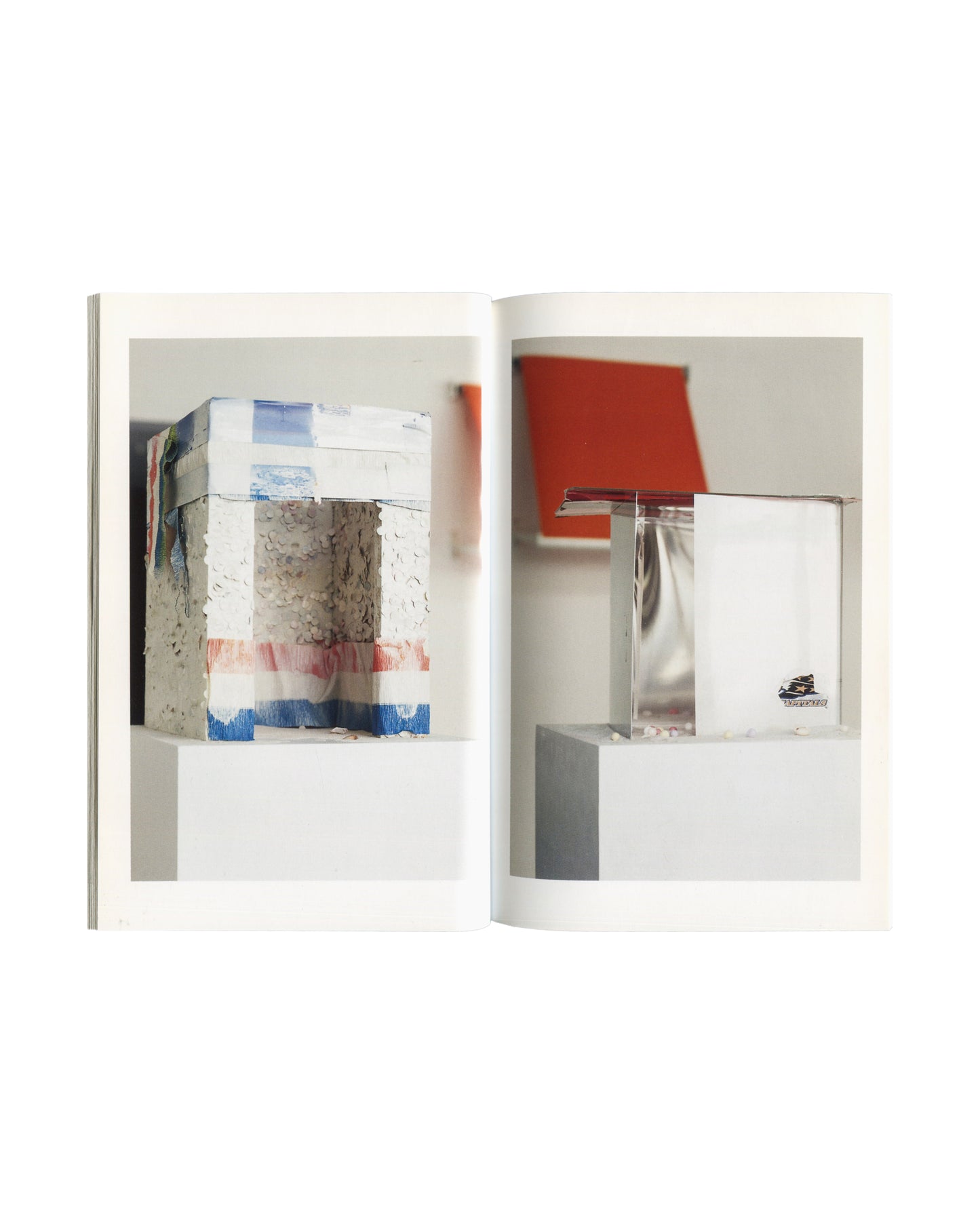 Isa Genzken, Urlaub, 2000 — interior spread showing two sculptural works with glass, tape, and mixed materials on white plinths