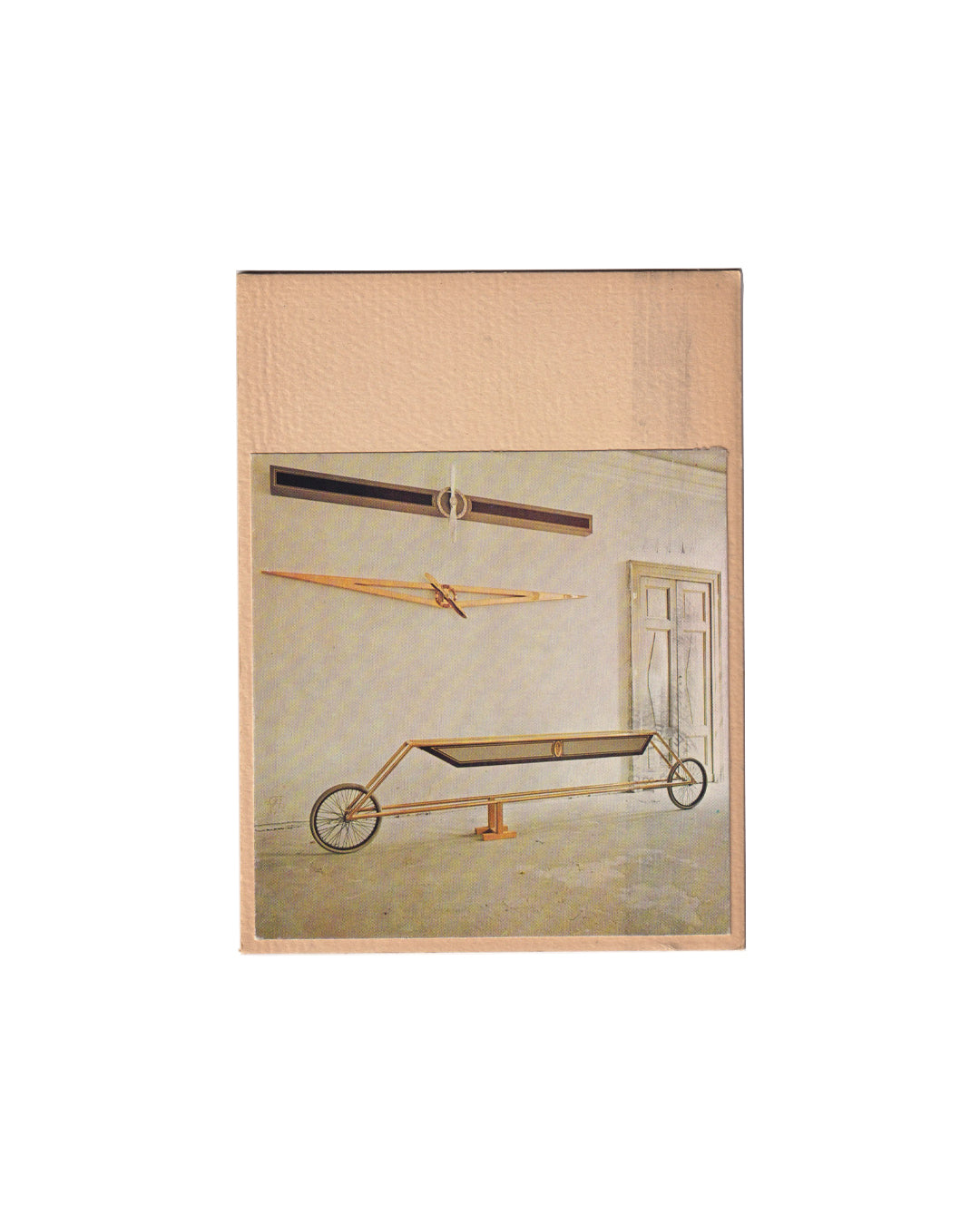 Recto (the front):

Gianni Piacentino, Stampe, Galleria Plura, Milan, 1980. Recto: applied colour photograph of installation view showing three engineered sculptural works — two wall-mounted linear forms and a wheeled floor vehicle — mounted onto cream card stock.