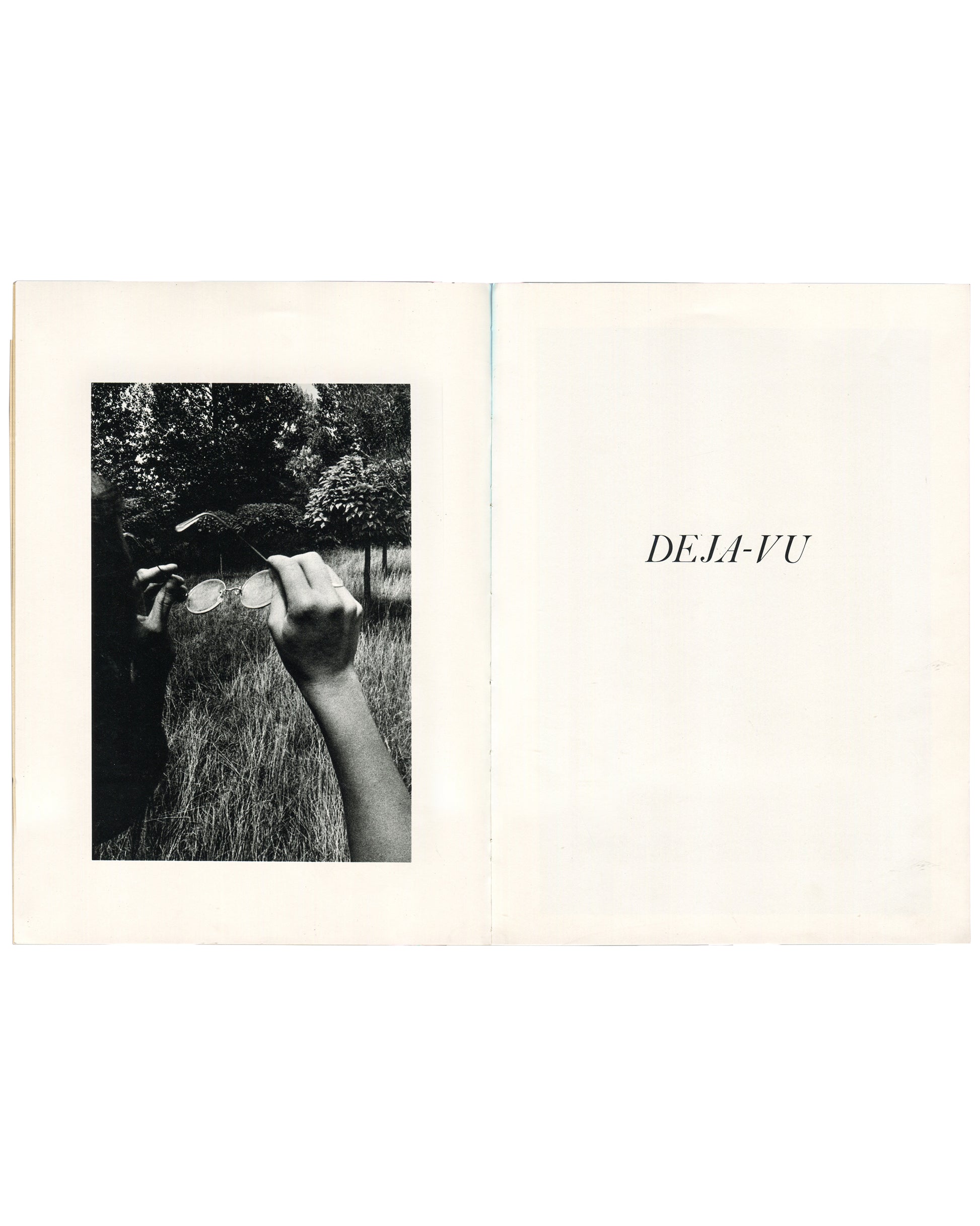 Interior spread of Ralph Gibson, Deja-Vu, Lustrum Press, 1973, left page showing a black-and-white photograph of a hand holding round wire-framed glasses against a garden background, right page showing the title DEJA-VU in italic serif type on white.